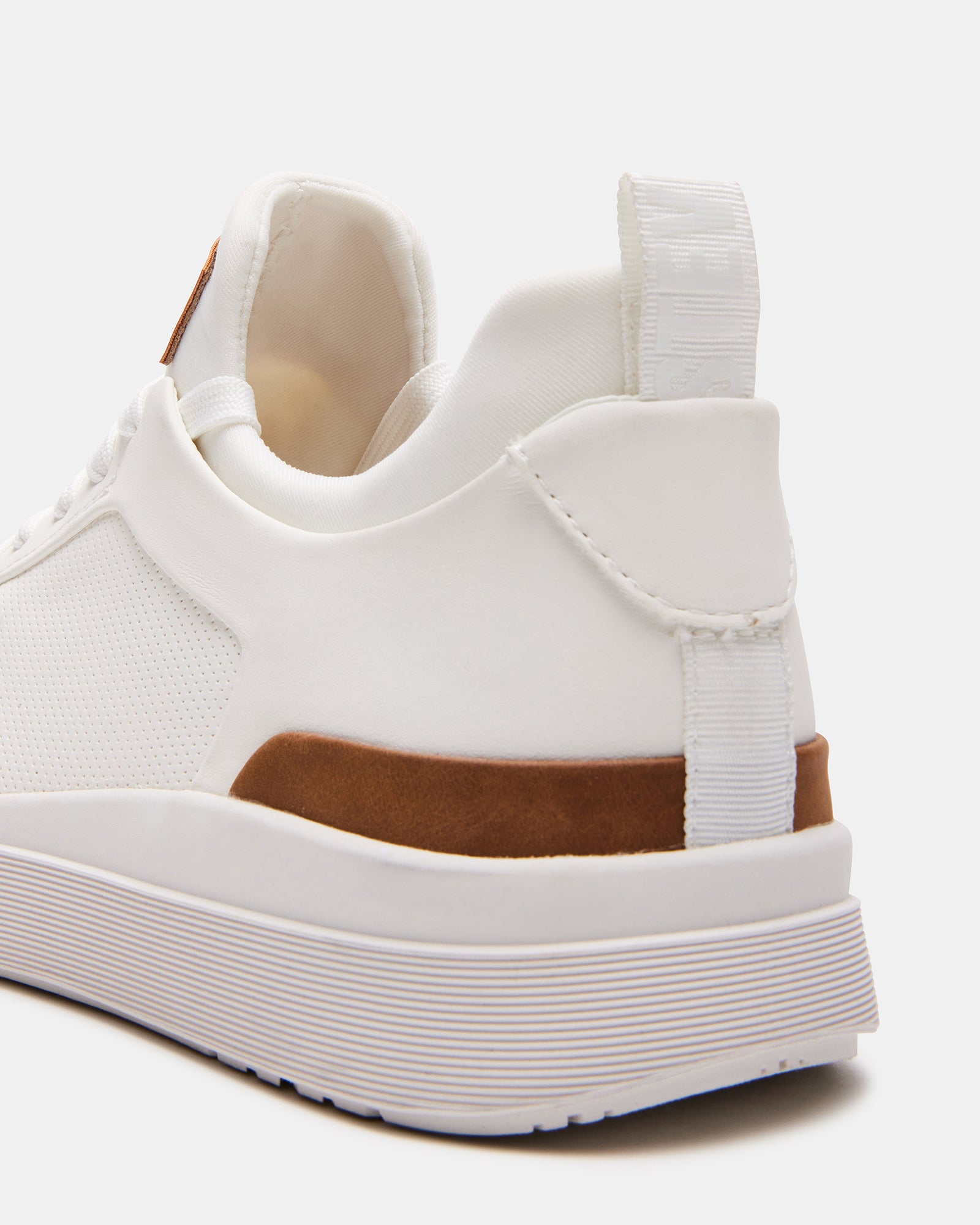 Father and child wearing matching white sneakers white during a Texas park stroll