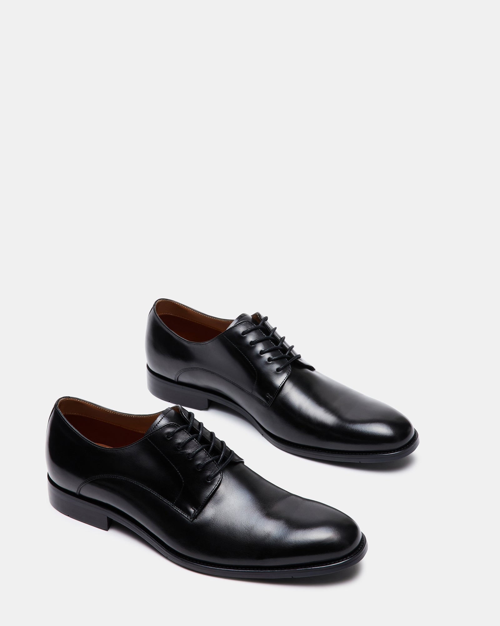 Male model wearing black leather derby shoes paired with a suit for a formal event