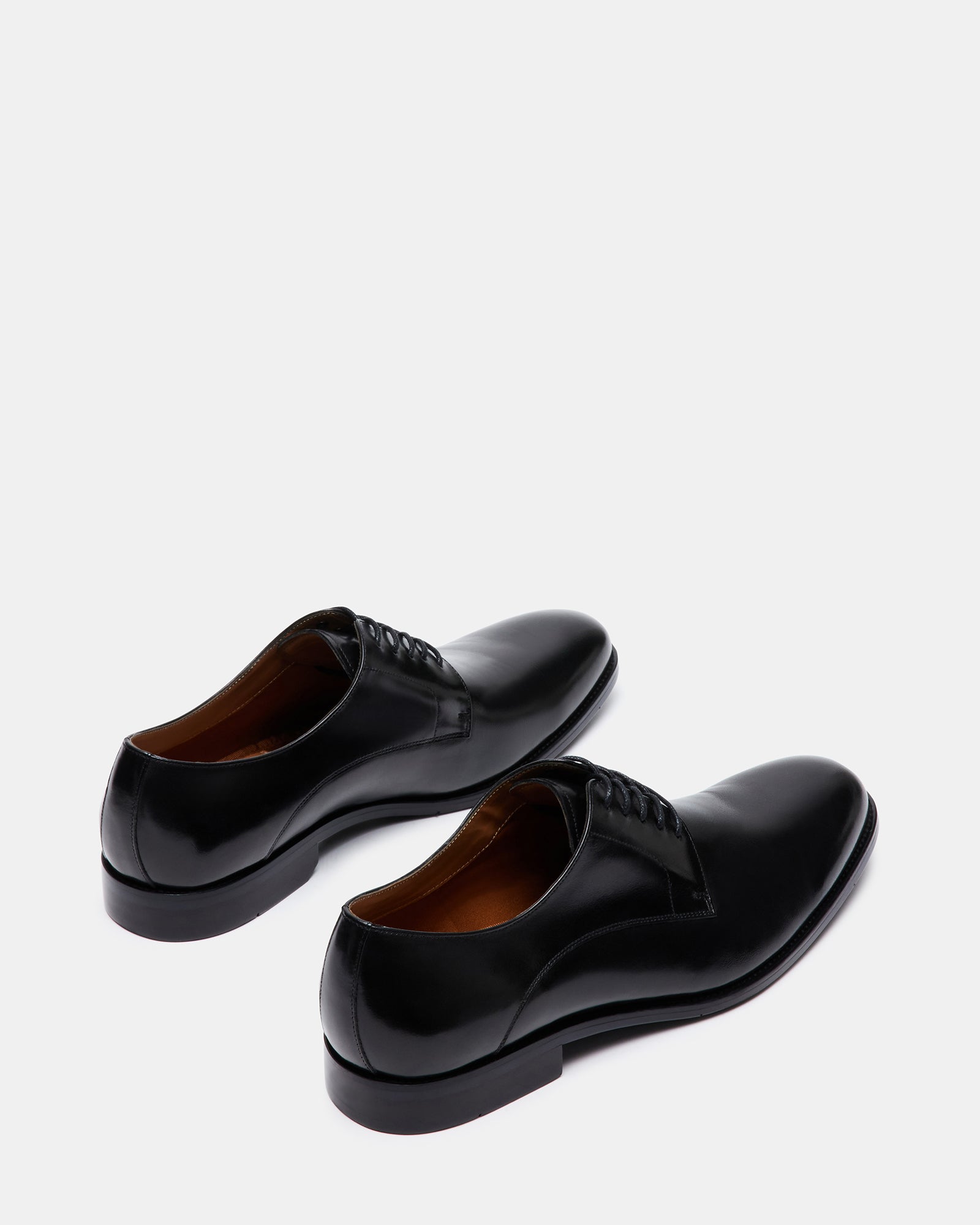 Male model wearing black leather derby shoes paired with a suit for a formal event