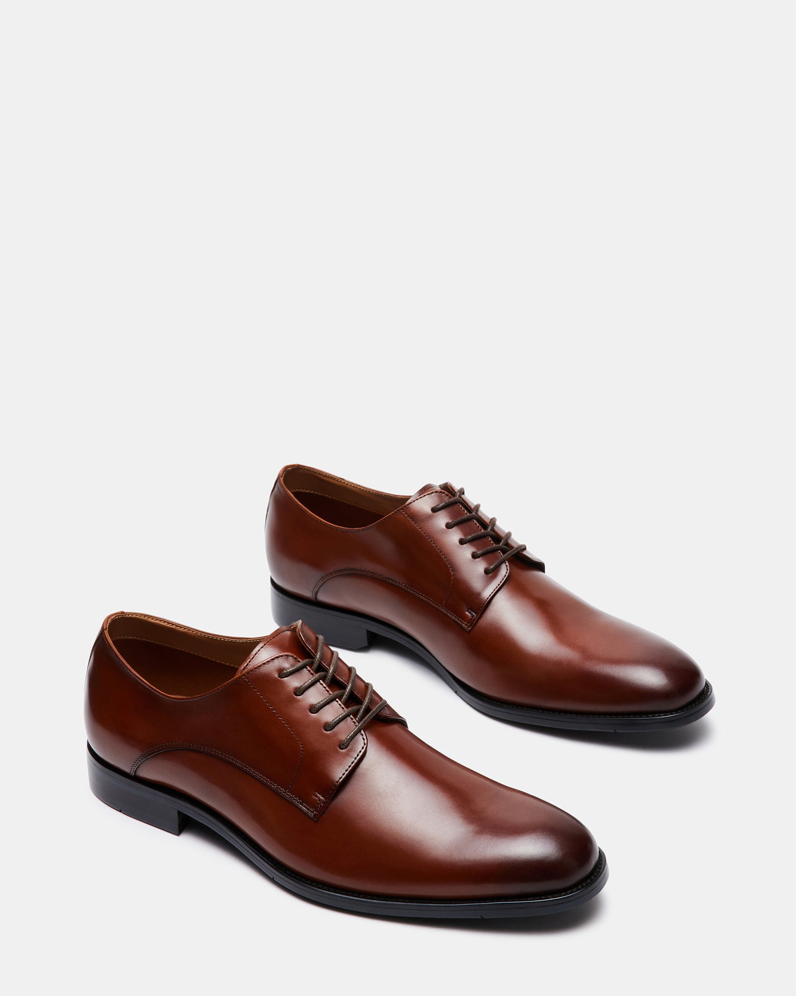 Close-up of laced derby shoes showing the leather finish