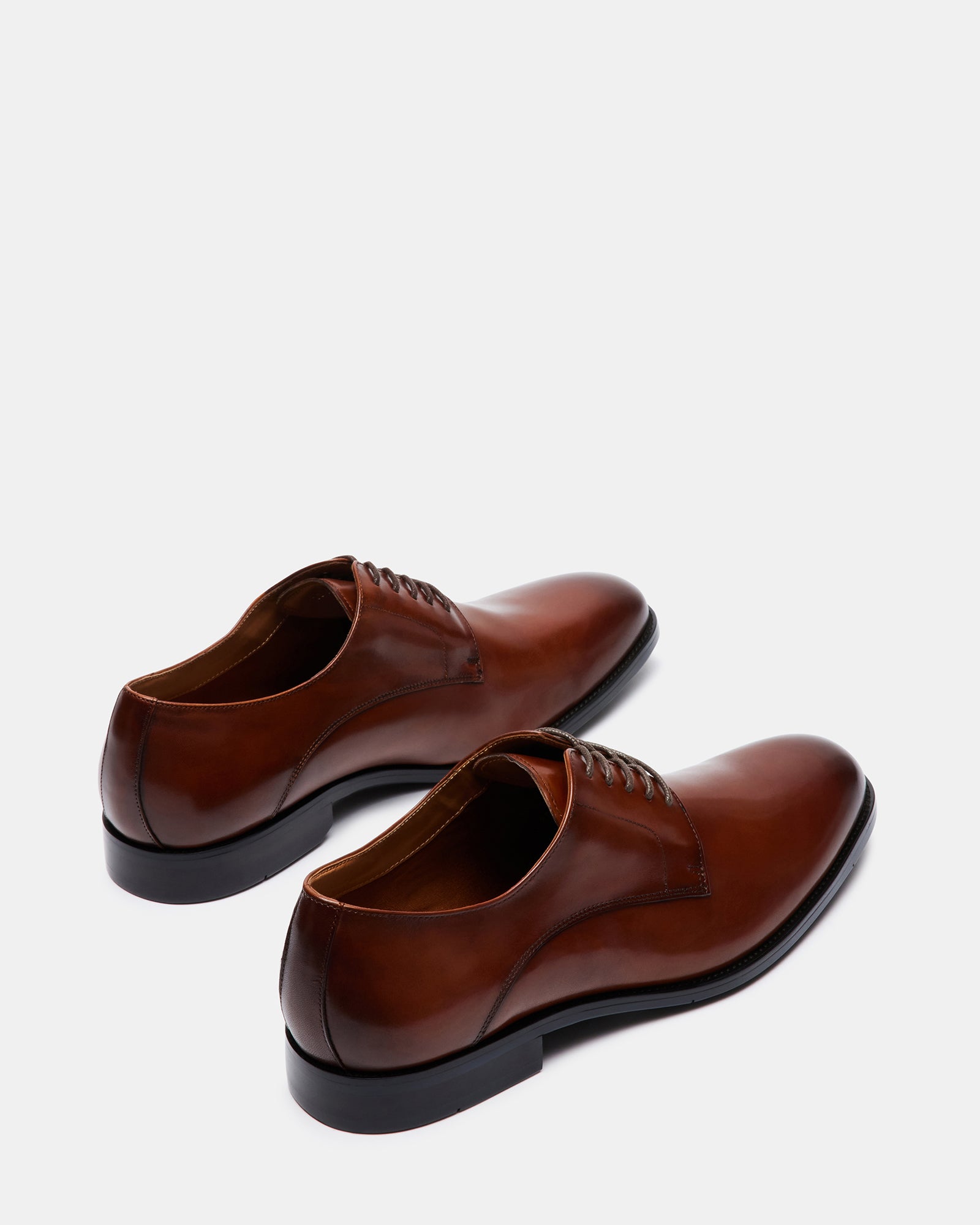 Close-up of laced derby shoes showing the leather finish