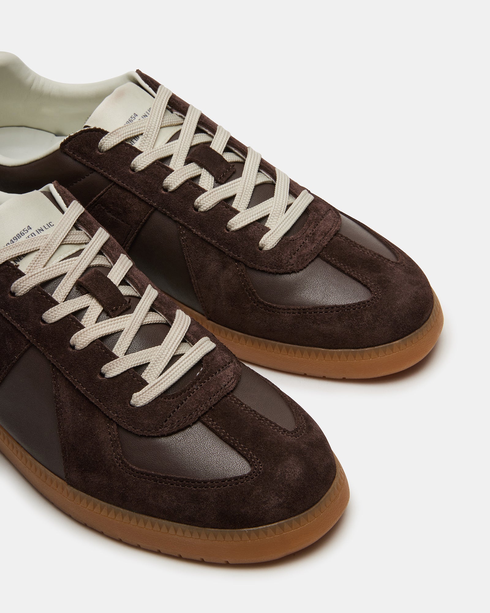 Top view of mens black sneakers showing lace-up detail and suede texture