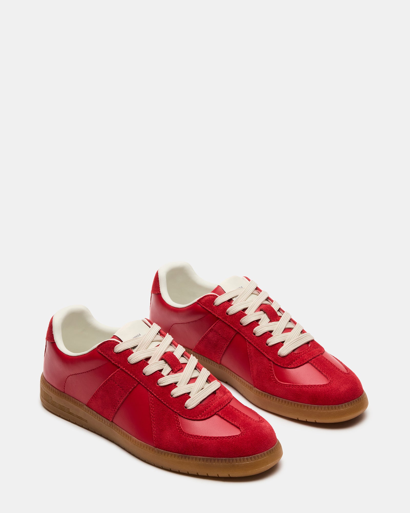 Side profile of low top sneakers highlighting the clean leather upper