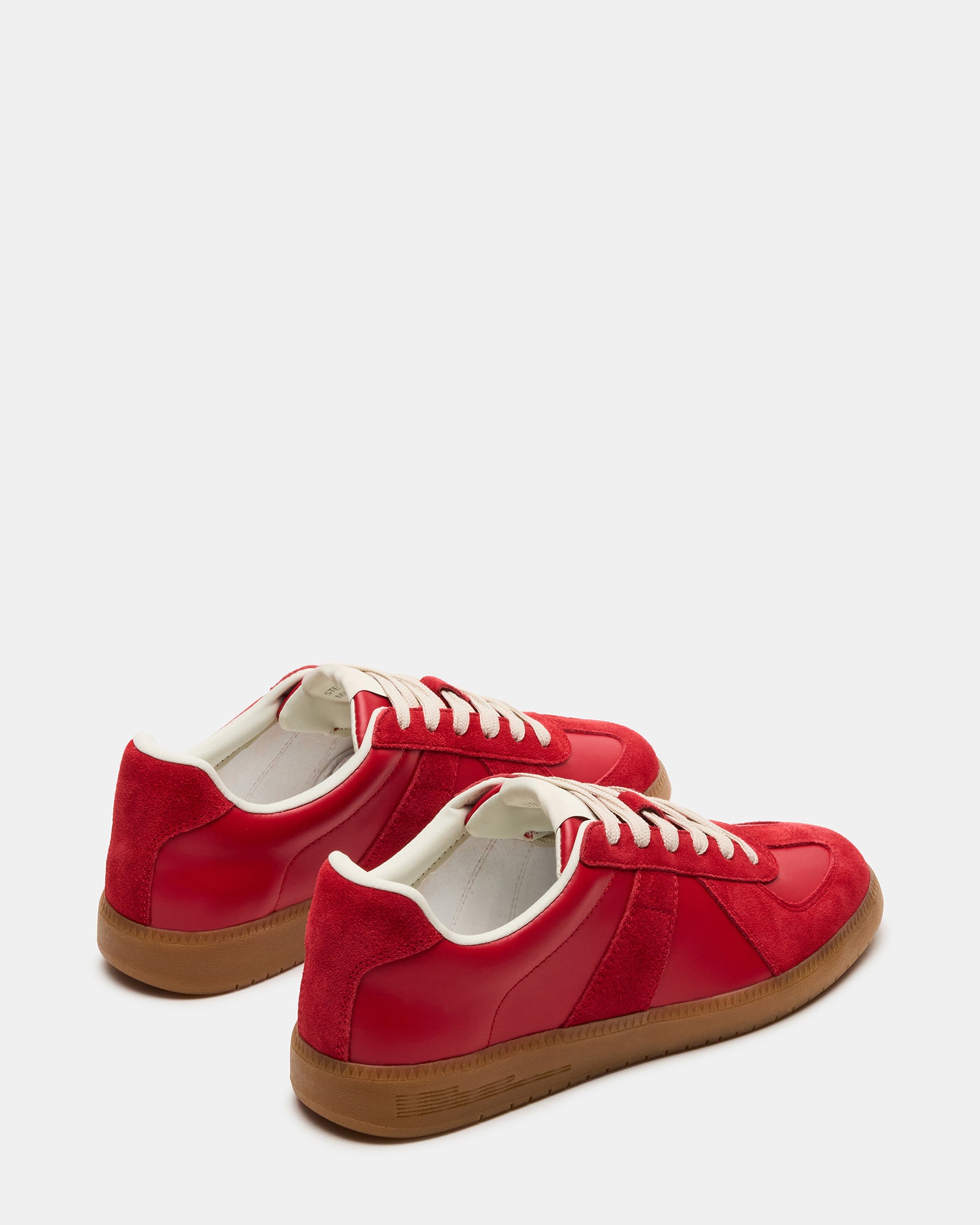 Side profile of low top sneakers highlighting the clean leather upper