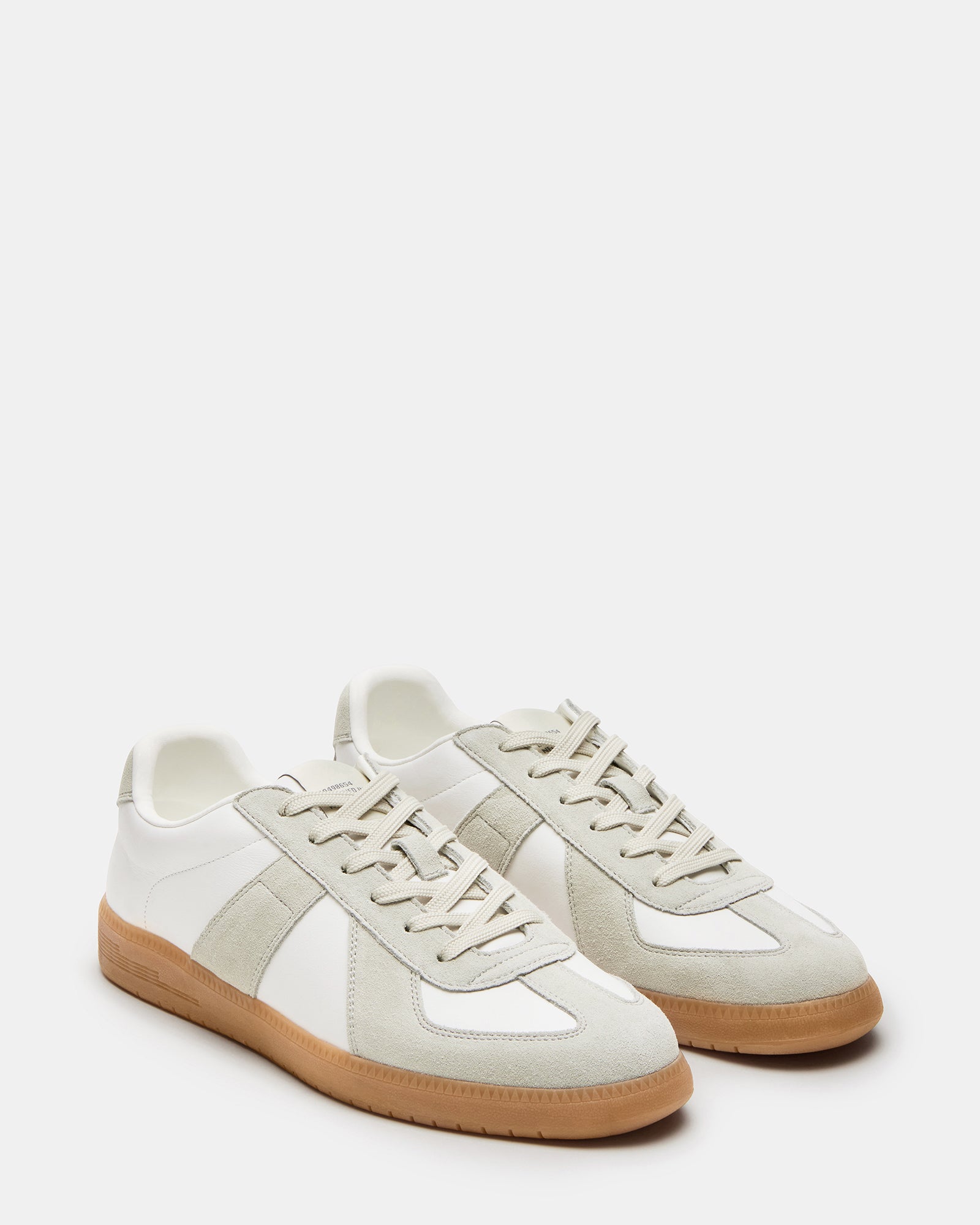 Lifestyle shot of DIXON sneakers worn with business casual attire on city streets