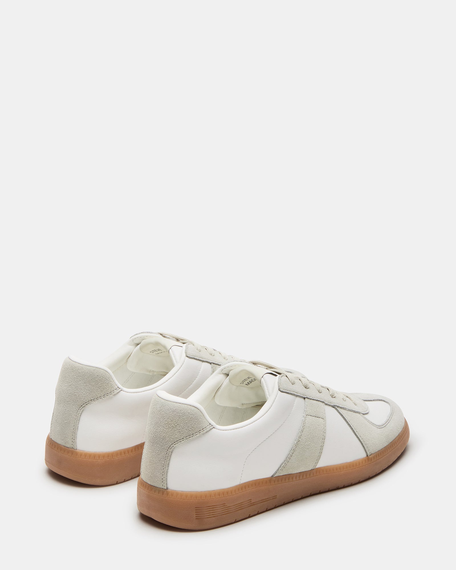 Lifestyle shot of DIXON sneakers worn with business casual attire on city streets