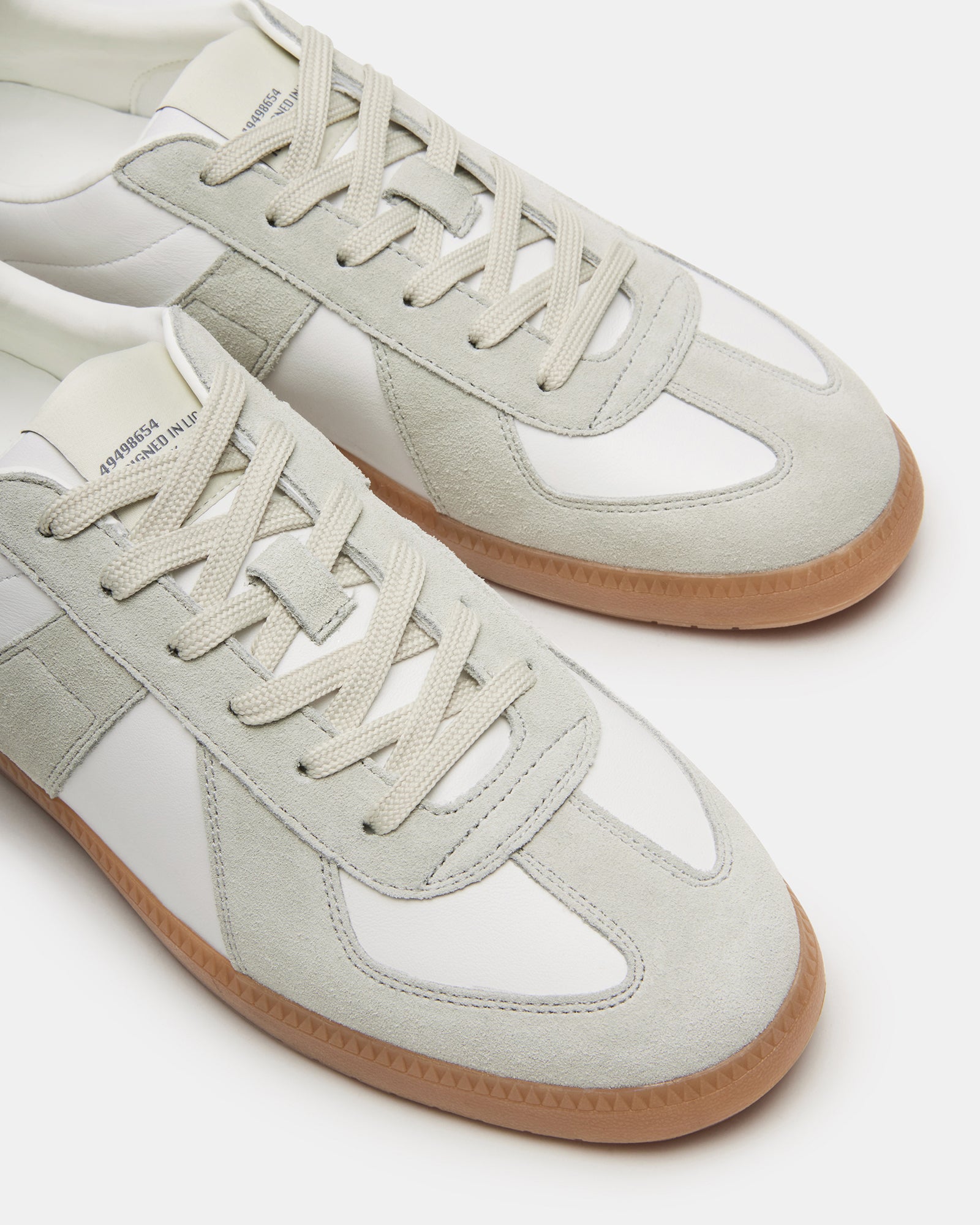 Side view of DIXON low-top sneakers showing suede and leather details