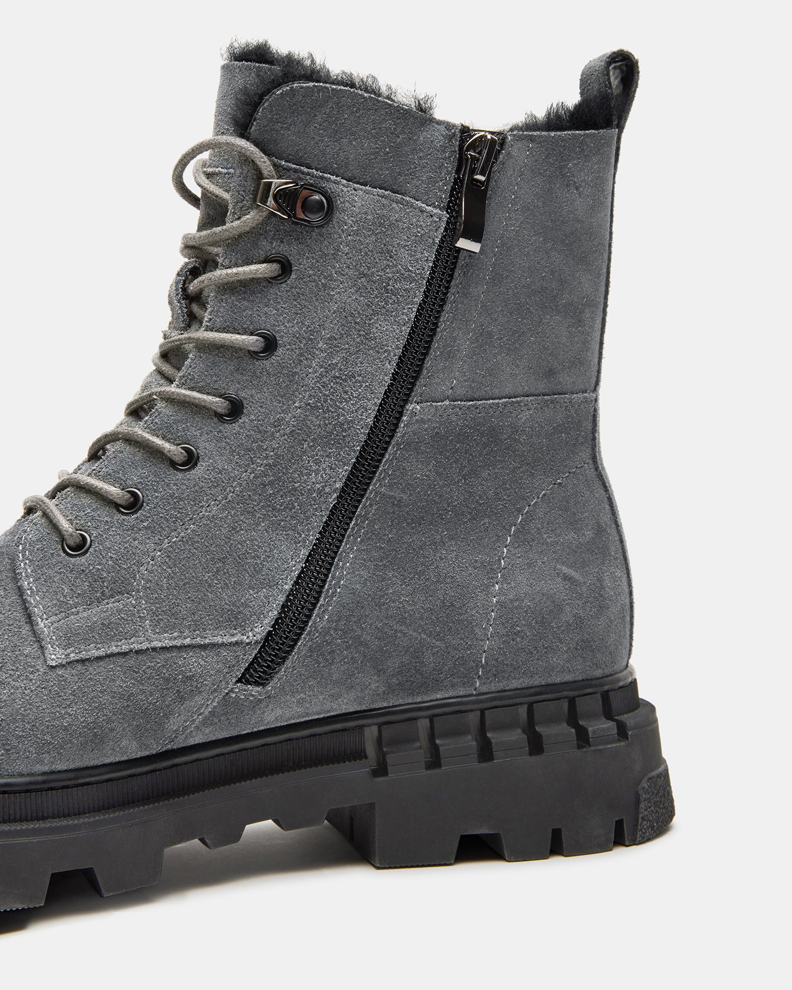 Black ankle boots styled with jeans on a city sidewalk