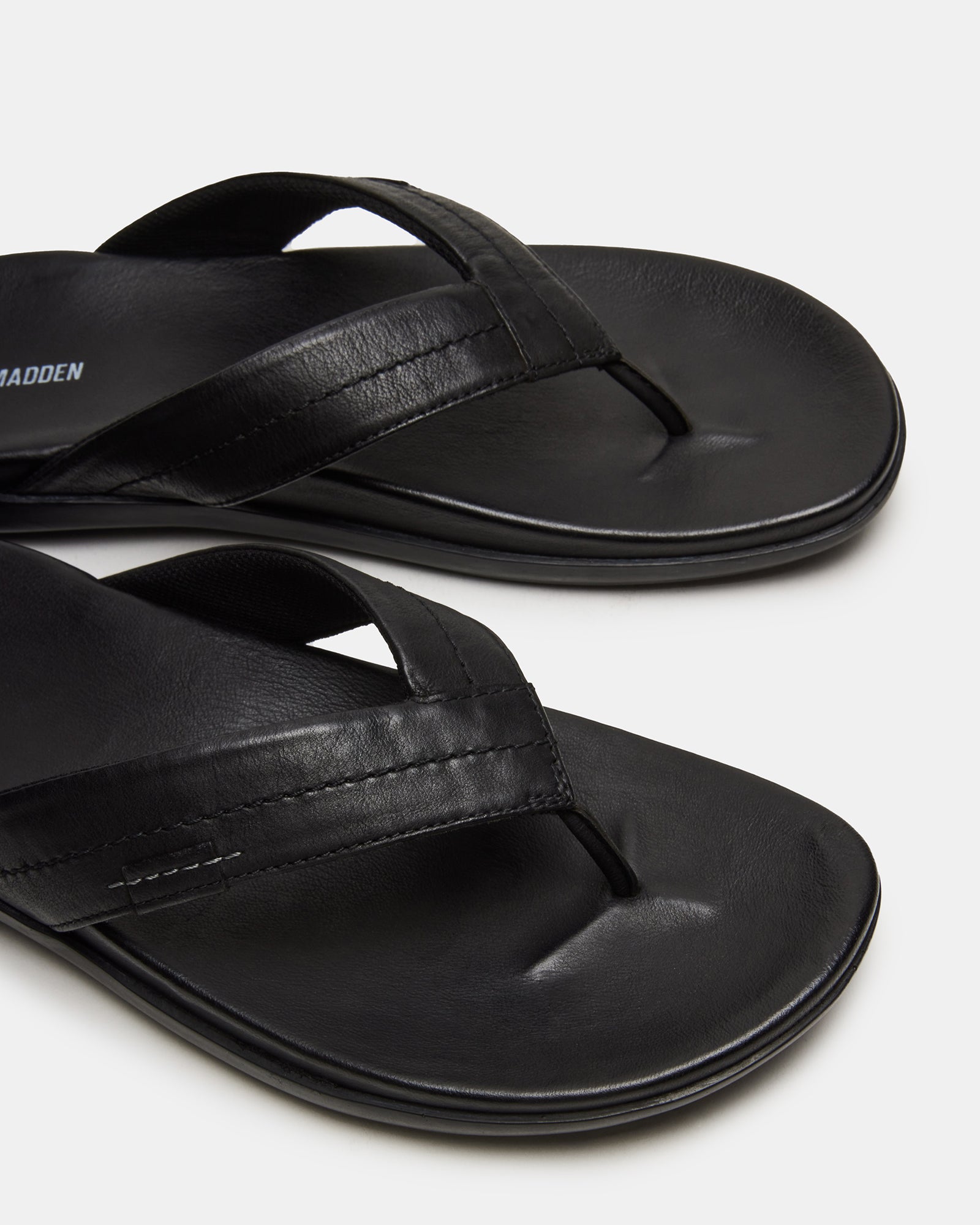 Emmett black flat sandals styled with a summer dress.