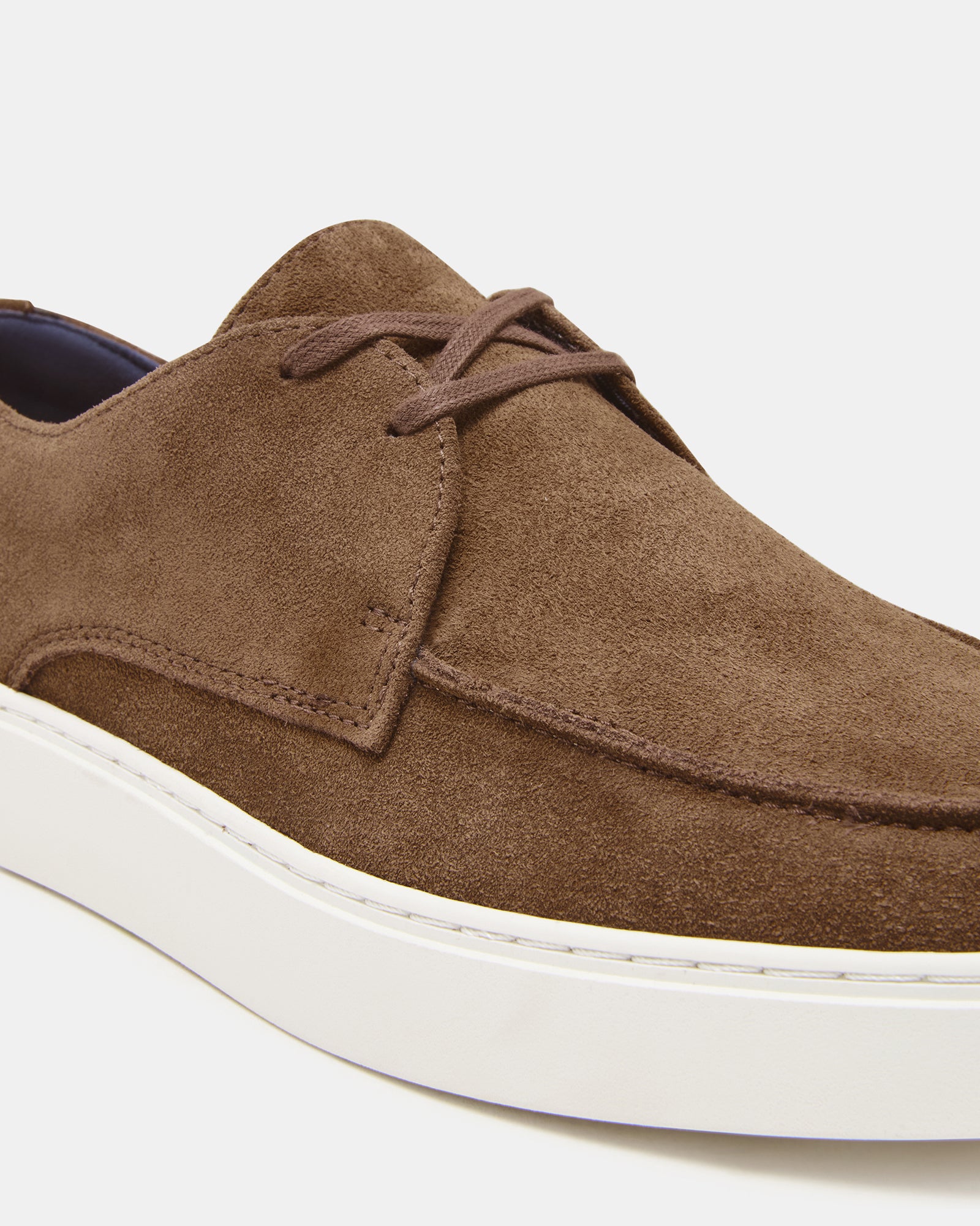 Side view of Frankk cognac suede lace-up shoes styled with denim