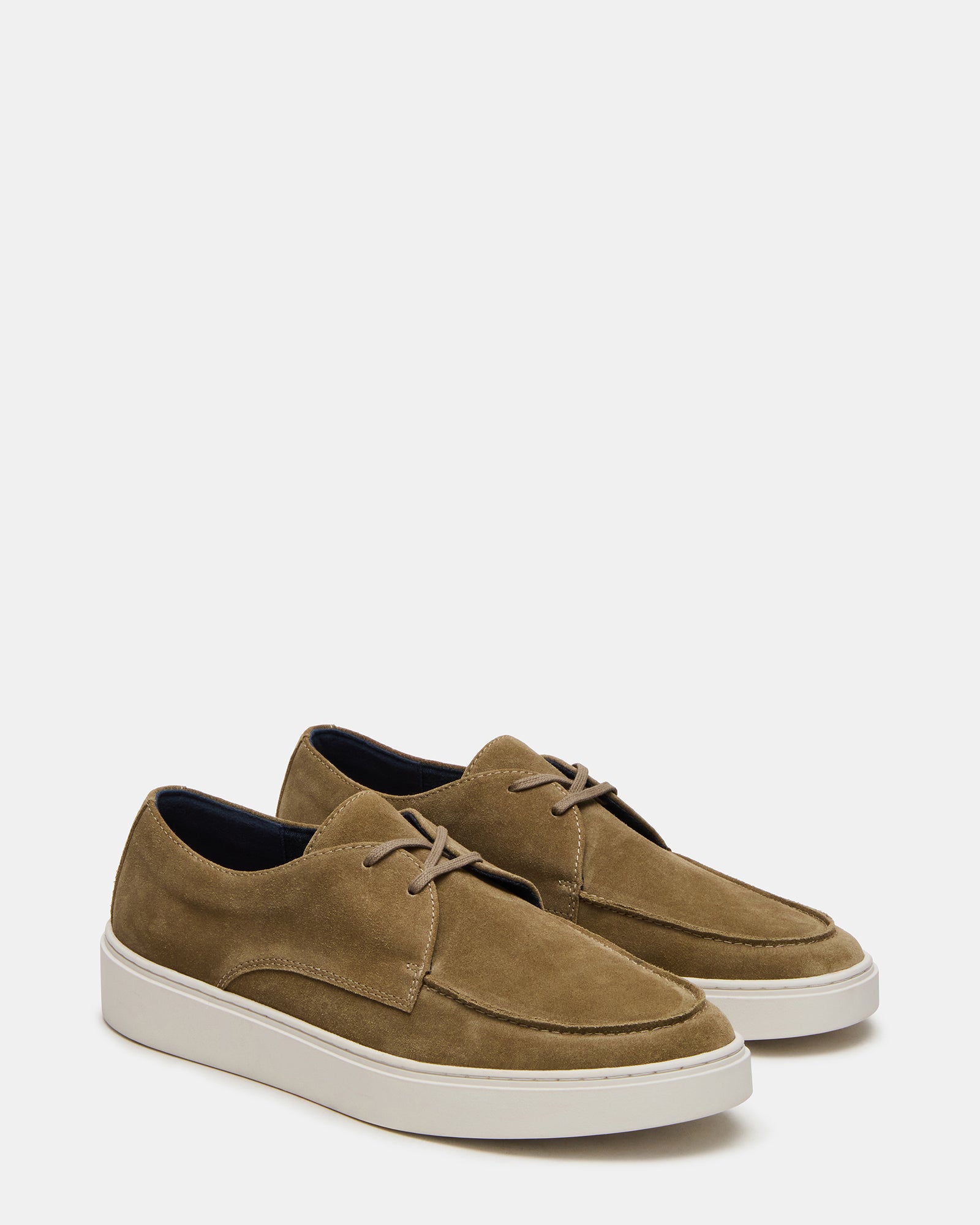 Lifestyle shot of casual shoes worn with rolled jeans outdoors
