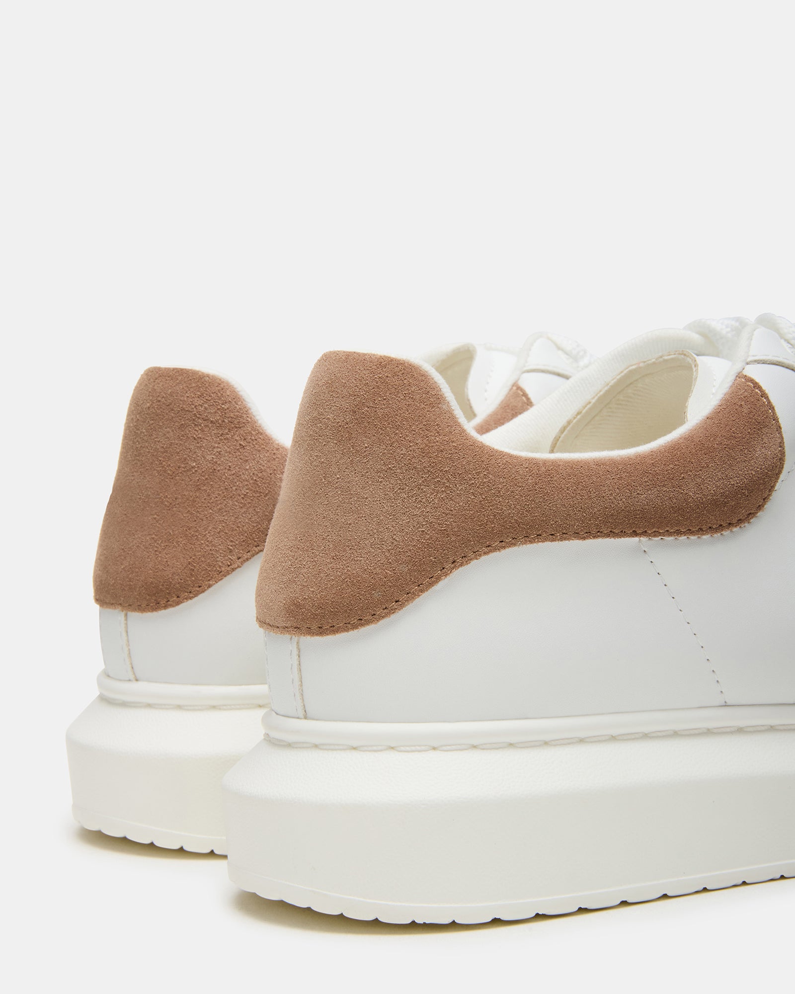 Front view of Frosted Taupe Multi platform sneakers on a wooden floor.