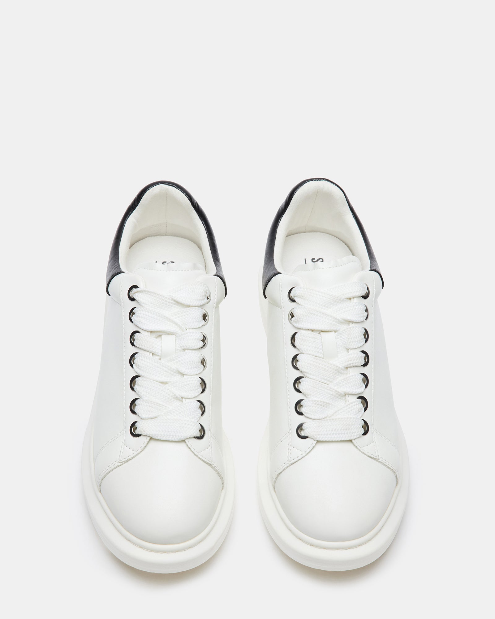 Street-style outfit featuring Frosted Flex white platform sneakers in an urban setting