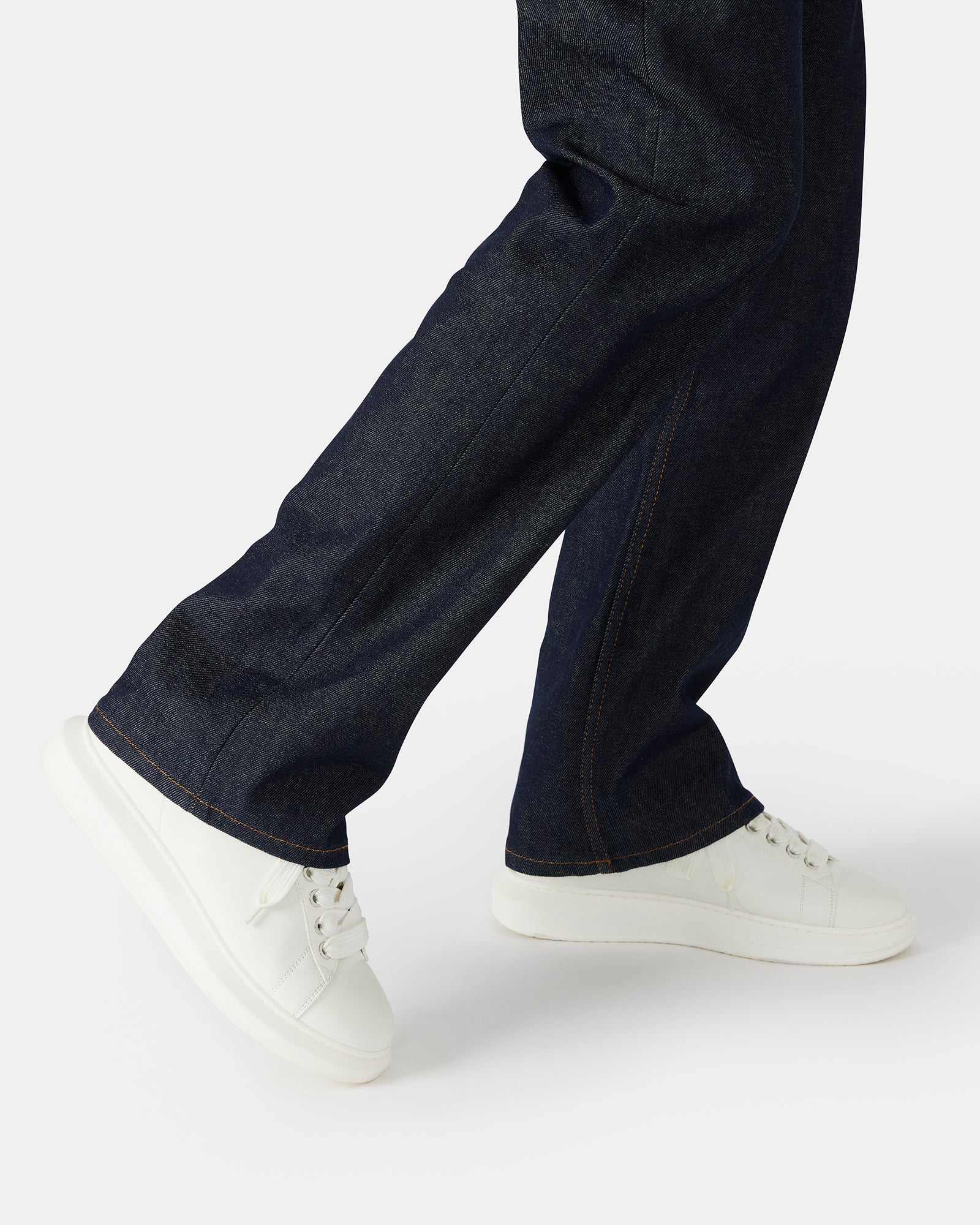 Street-style outfit featuring Frosted Flex white platform sneakers in an urban setting