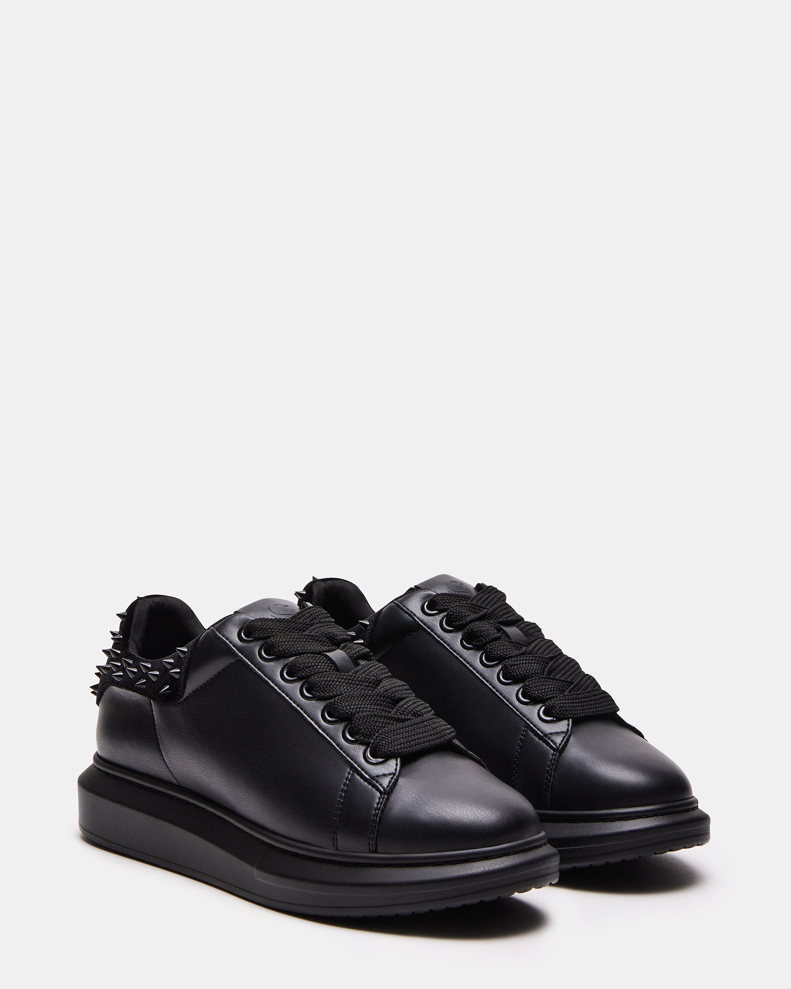 Close-up of the chunky rubber sole and spike details for streetwear fashion