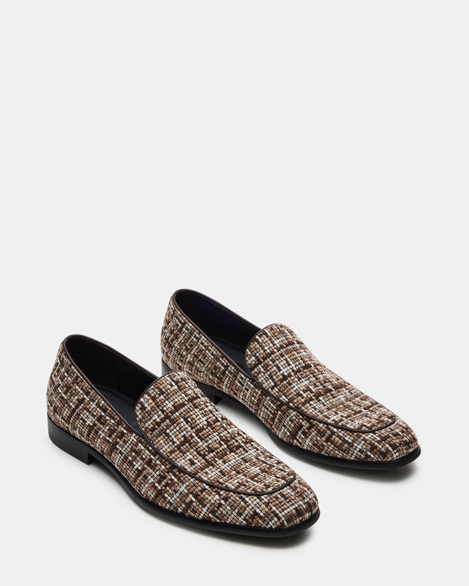 Close-up of woven tweed texture on mens white dress loafers