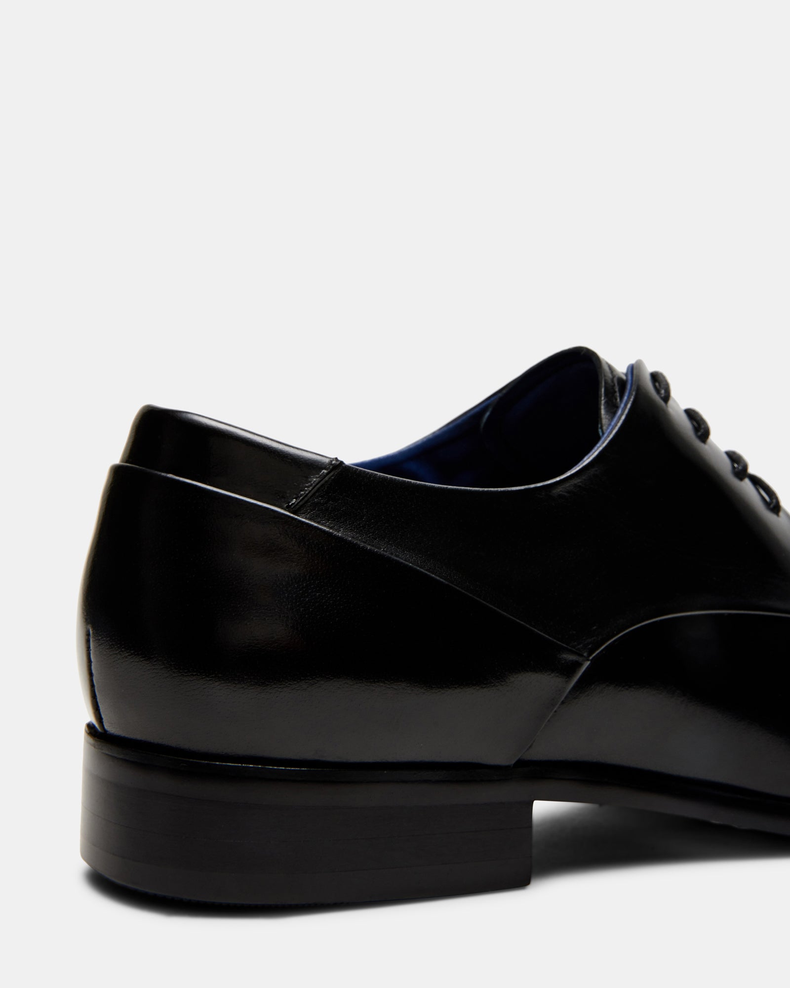 Black leather oxford dress shoes with almond toe and lace-up closure for men