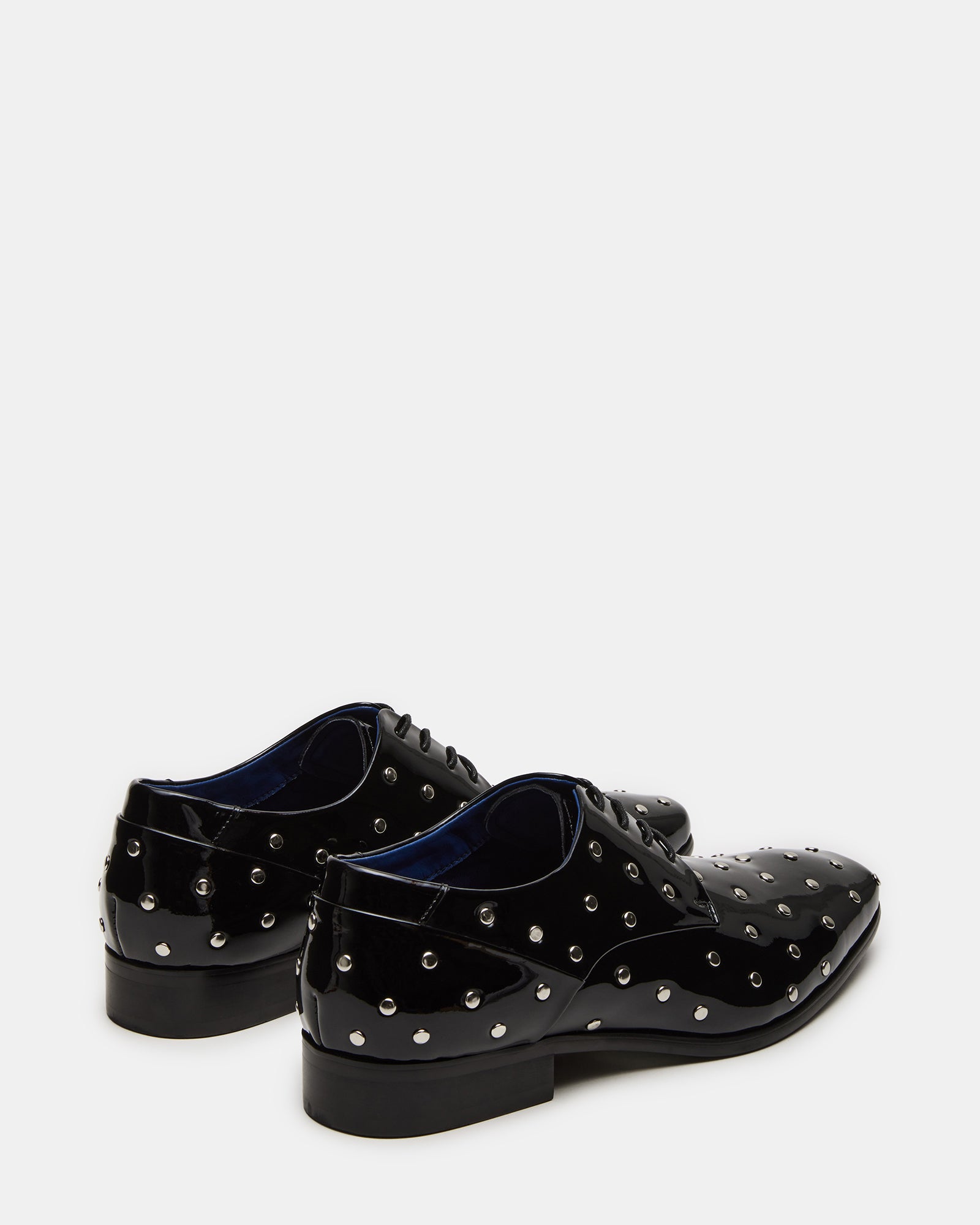 Close-up of oxford lace-up design on black patent shoes