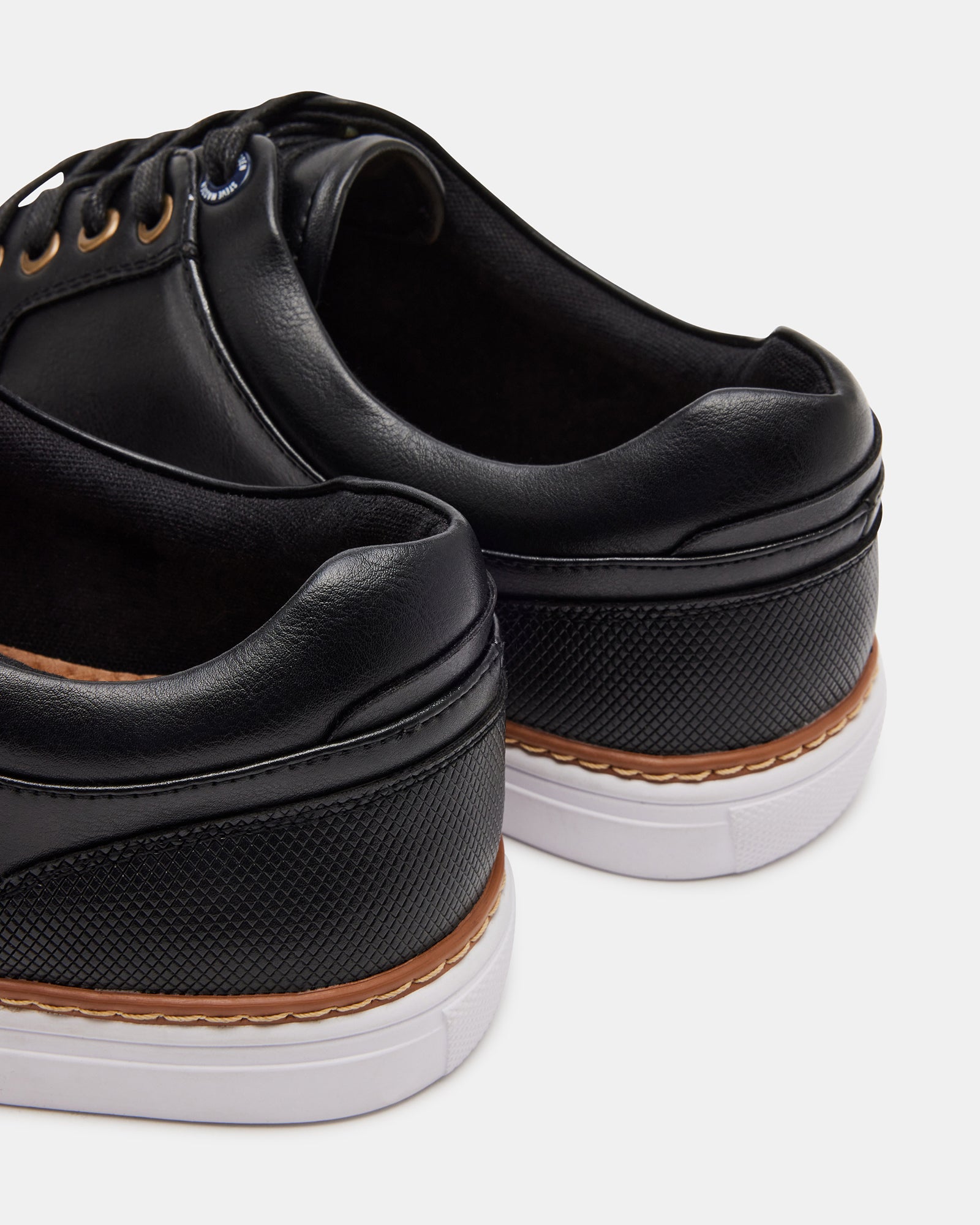GUSS BLACK mens casual shoes displayed on a wooden bench outdoors