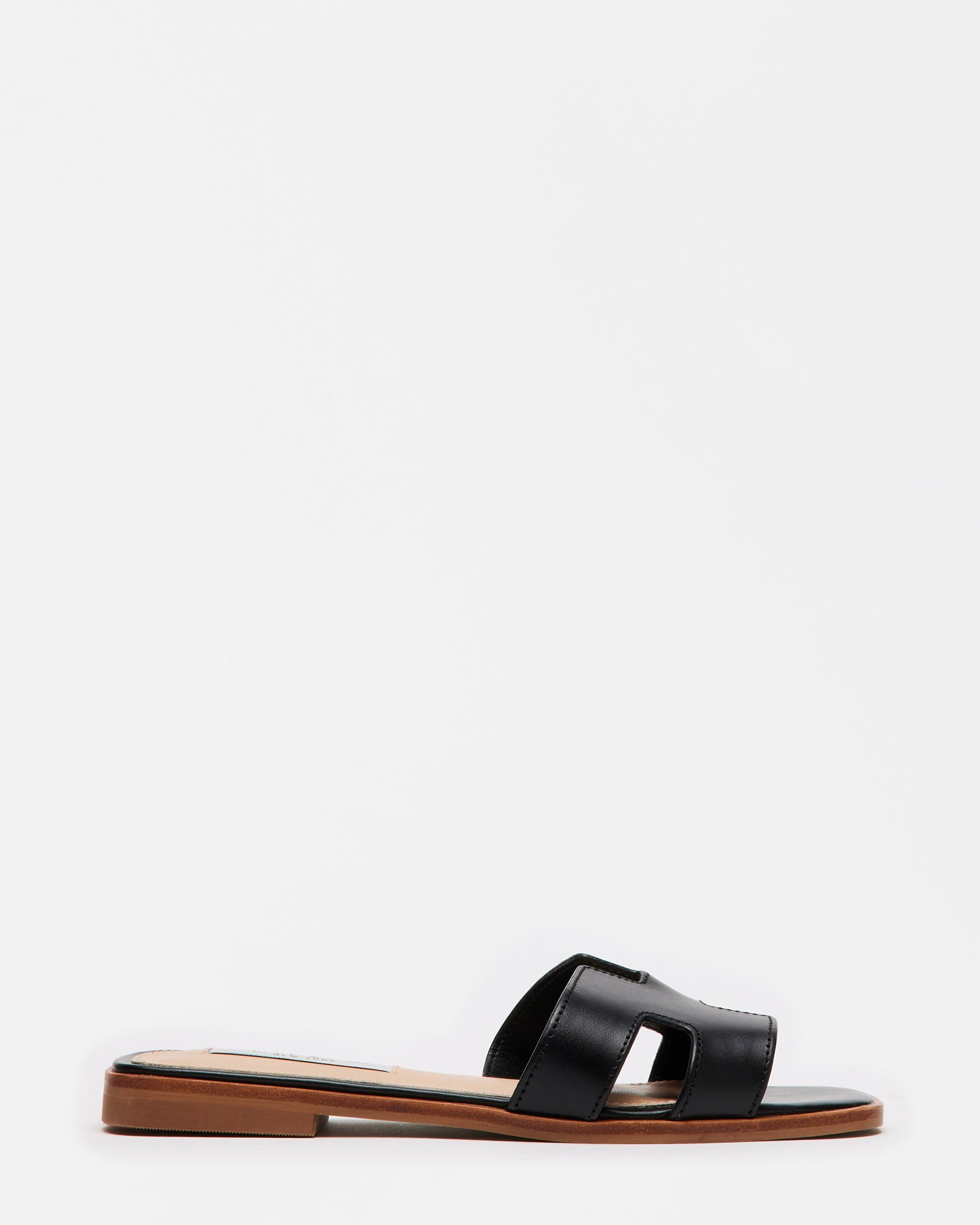 Side view of black leather sandals showing geometric strap cutouts
