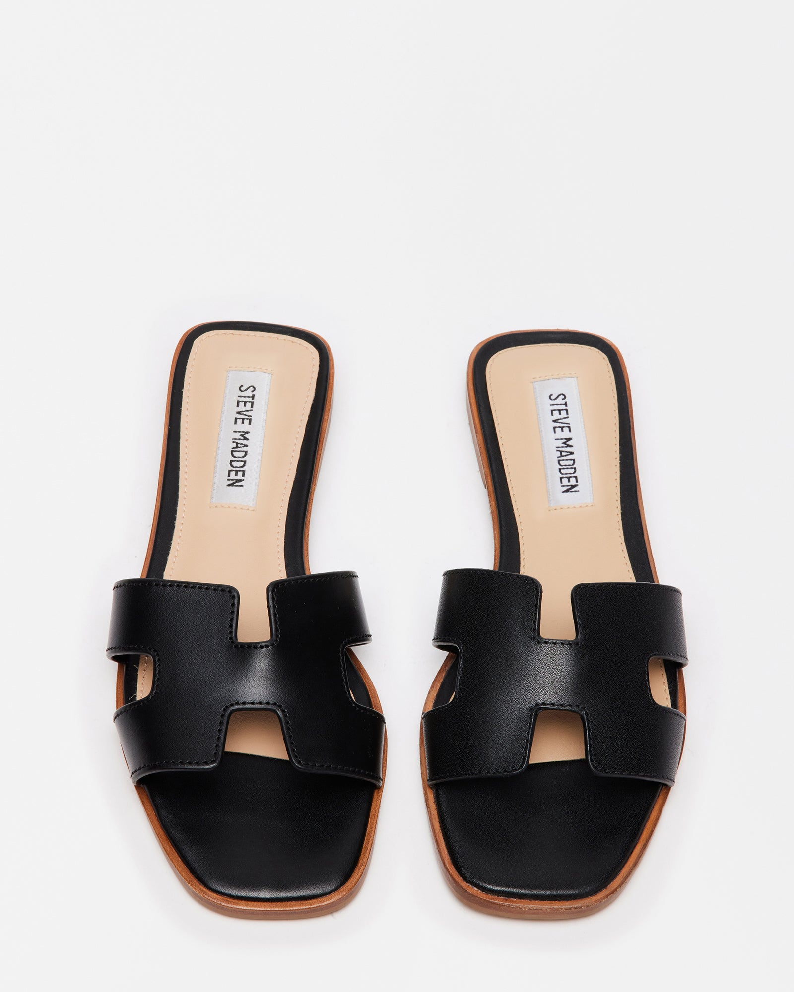 Side view of black leather sandals showing geometric strap cutouts