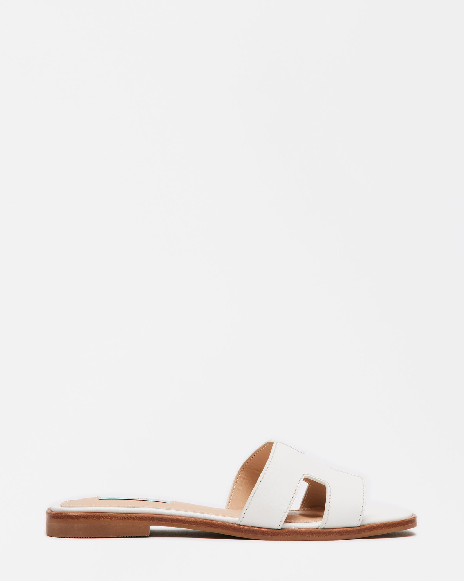 Hayden white leather sandals showcasing geometric cutouts from the side.