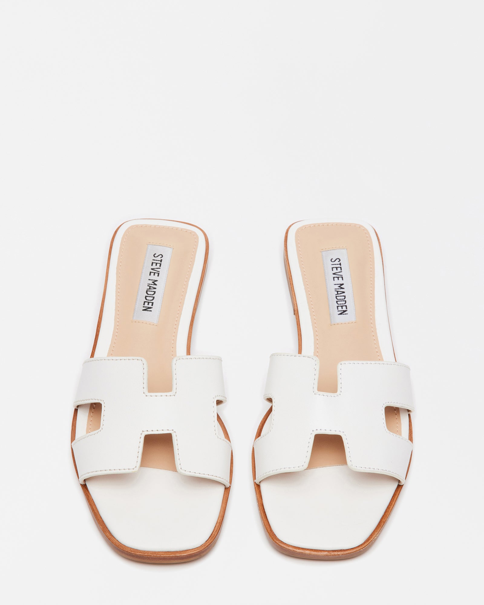 Hayden white leather sandals showcasing geometric cutouts from the side.
