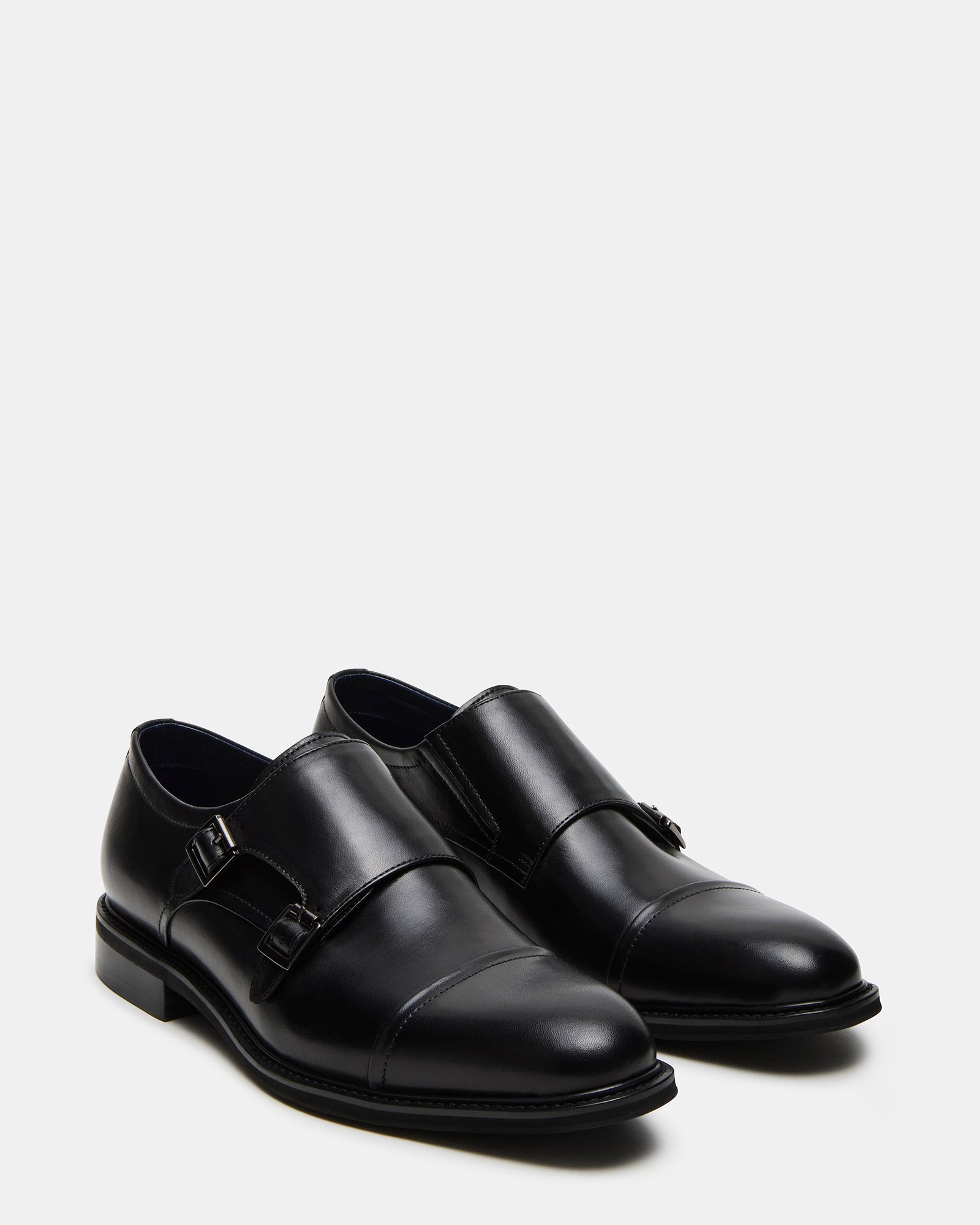 Close-up of the buckle on Haran black leather dress shoes.