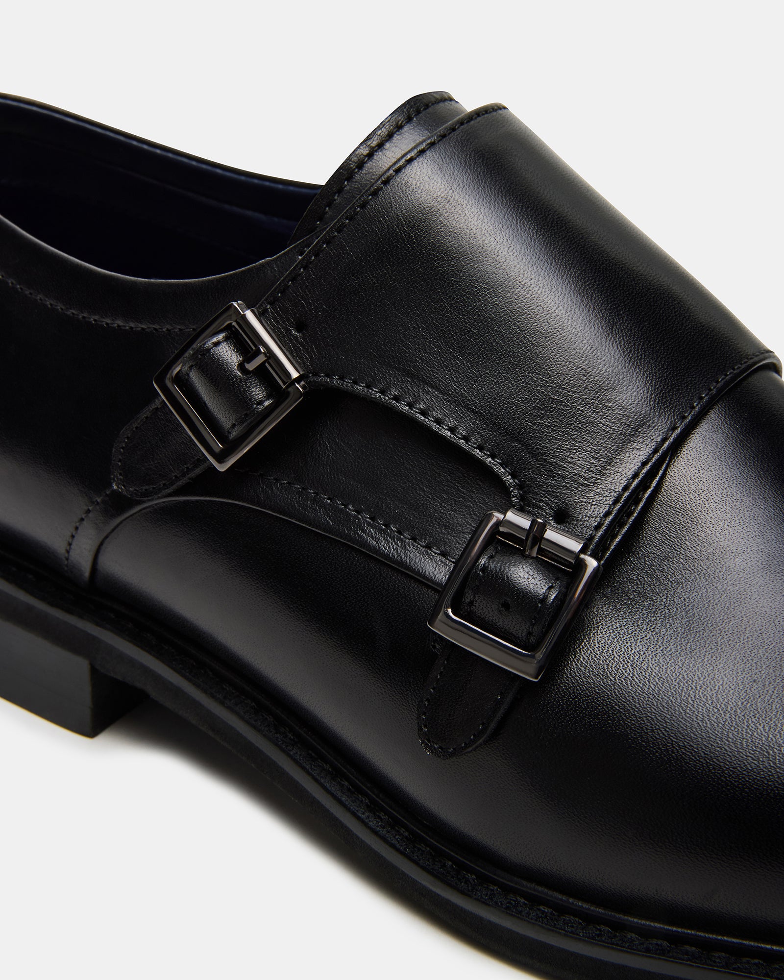 Haran buckle dress shoes in black leather, angled view.