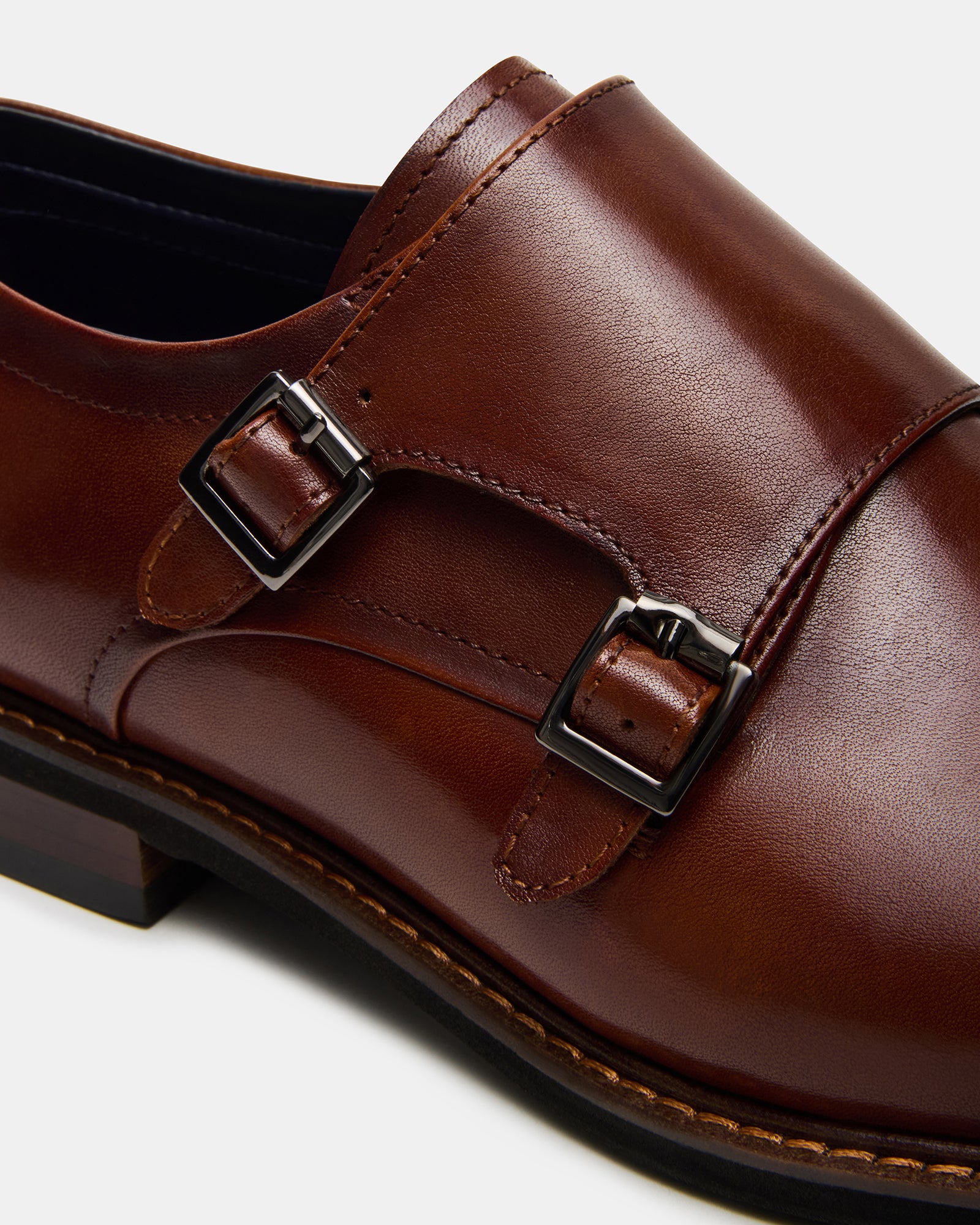 Side view of elegant black mens dress shoes with buckle design.