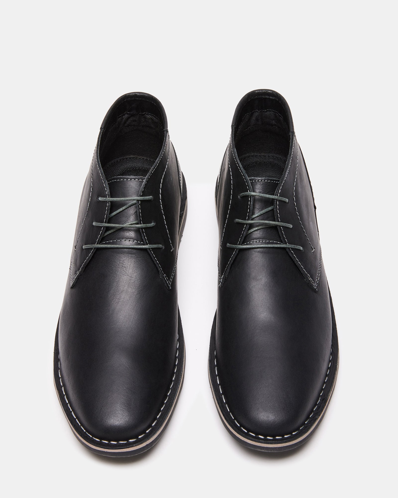 Front view of black leather chukka a boot styled with jeans.