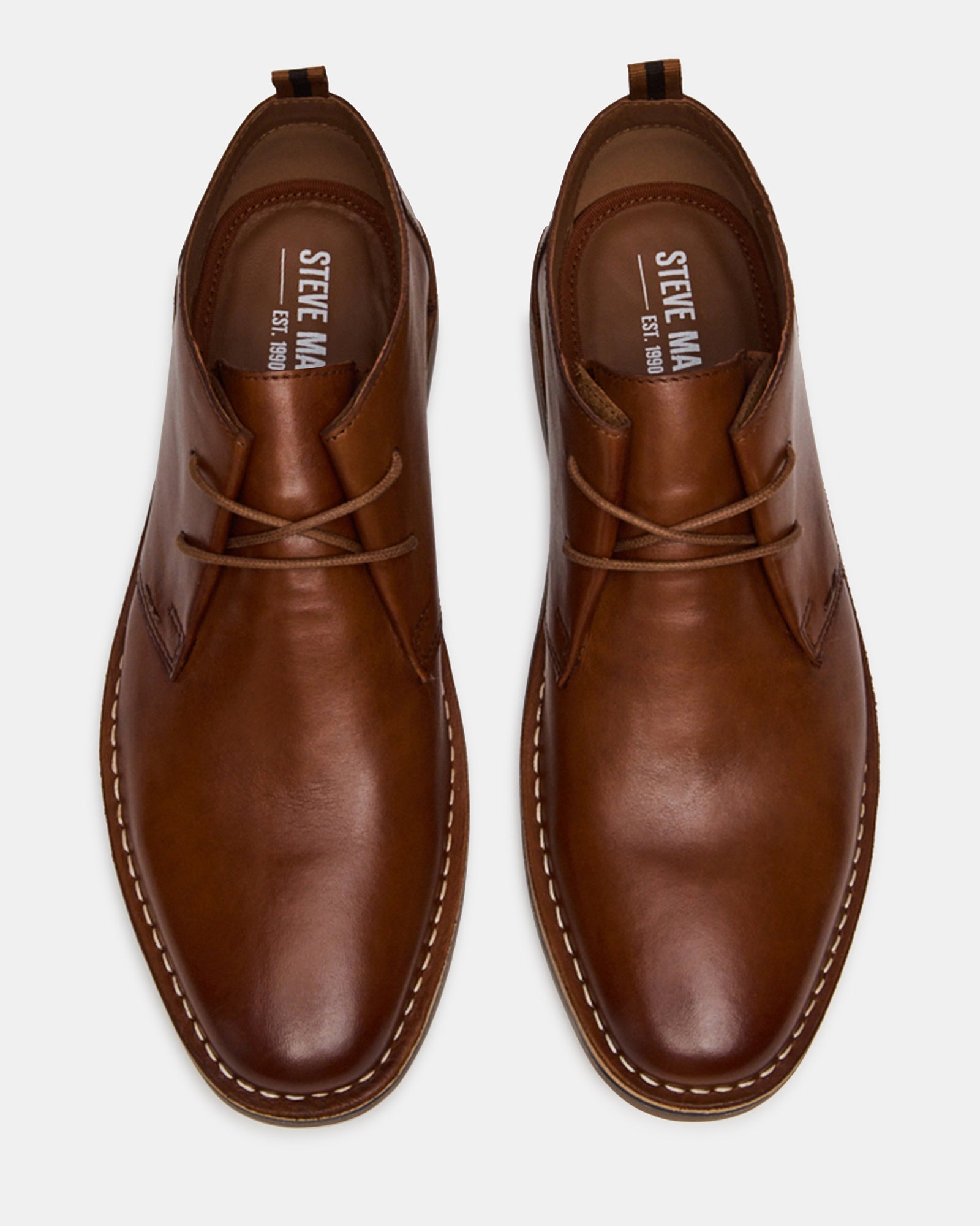 Close-up of handcrafted brown leather detailing on Chelsea boots