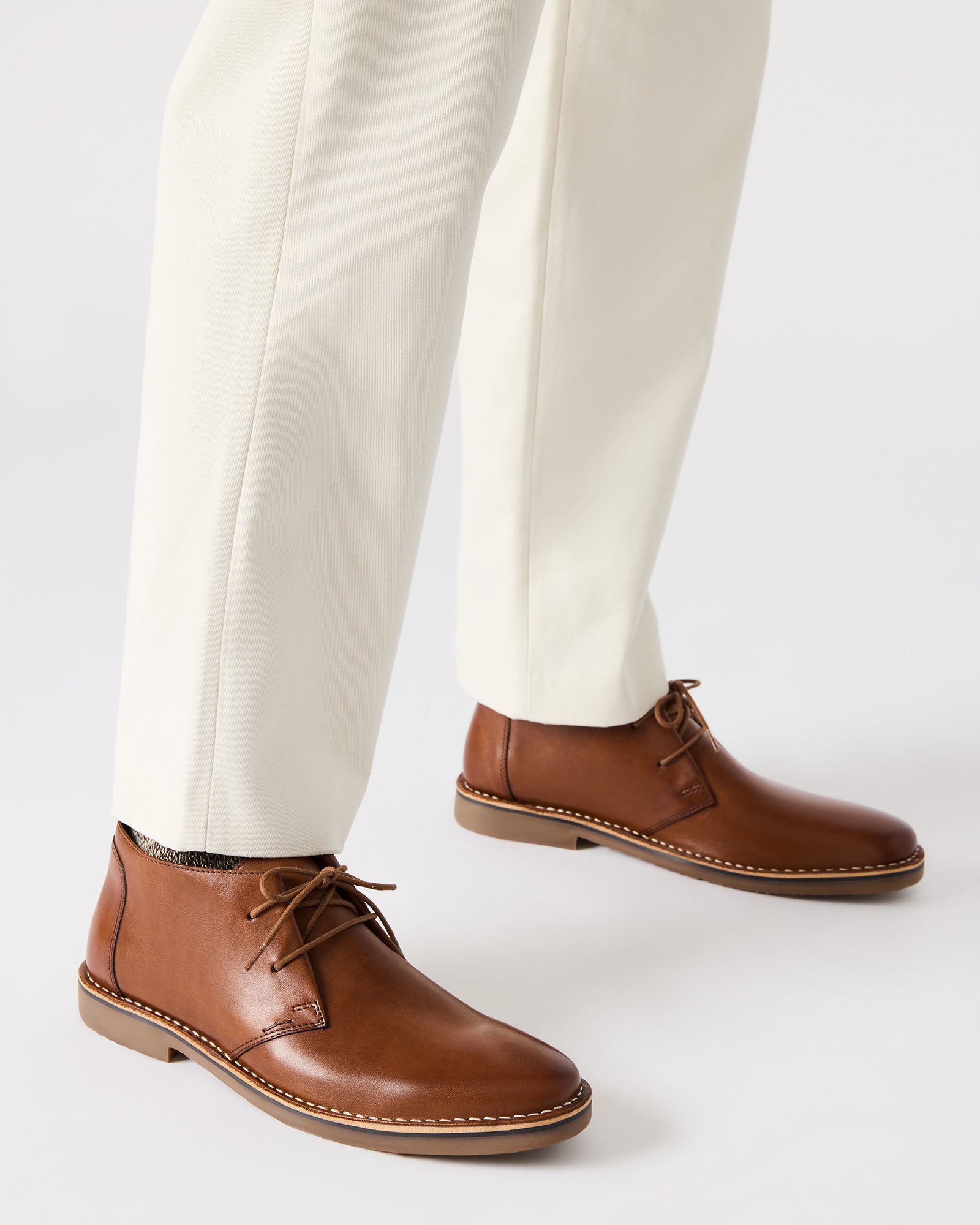 Close-up of handcrafted brown leather detailing on Chelsea boots