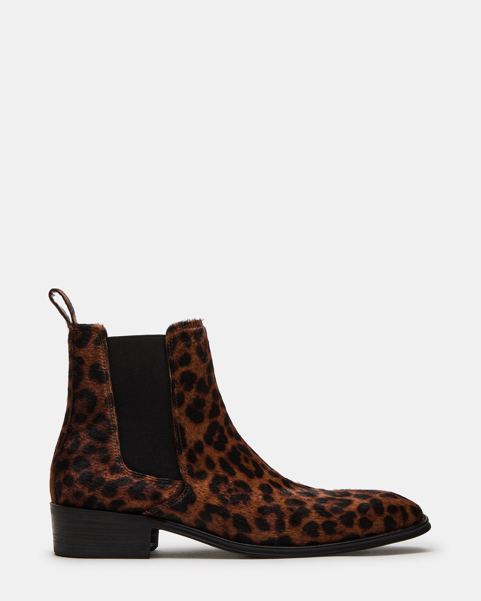 Side view of leopard print cowgirl boots on a wooden floor