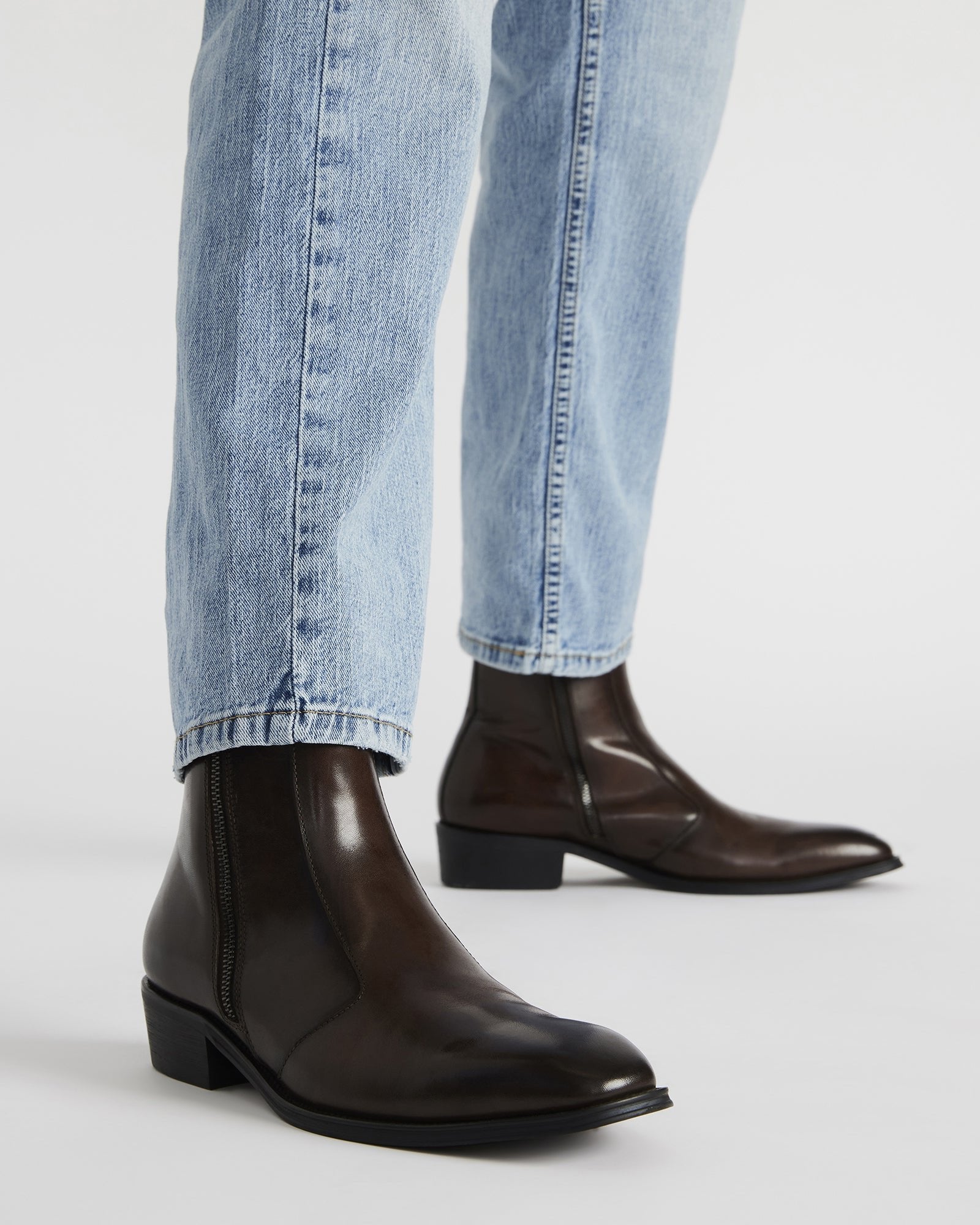 Side angle of brown leather ankle boots highlighting the block heel.
