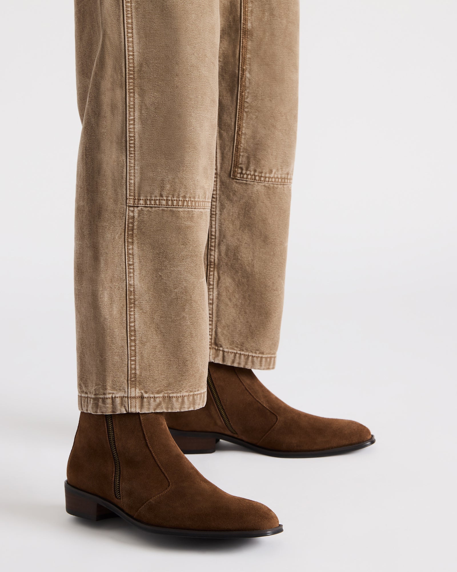 Front angle of Haynes suede dress boots highlighting polished block heel.