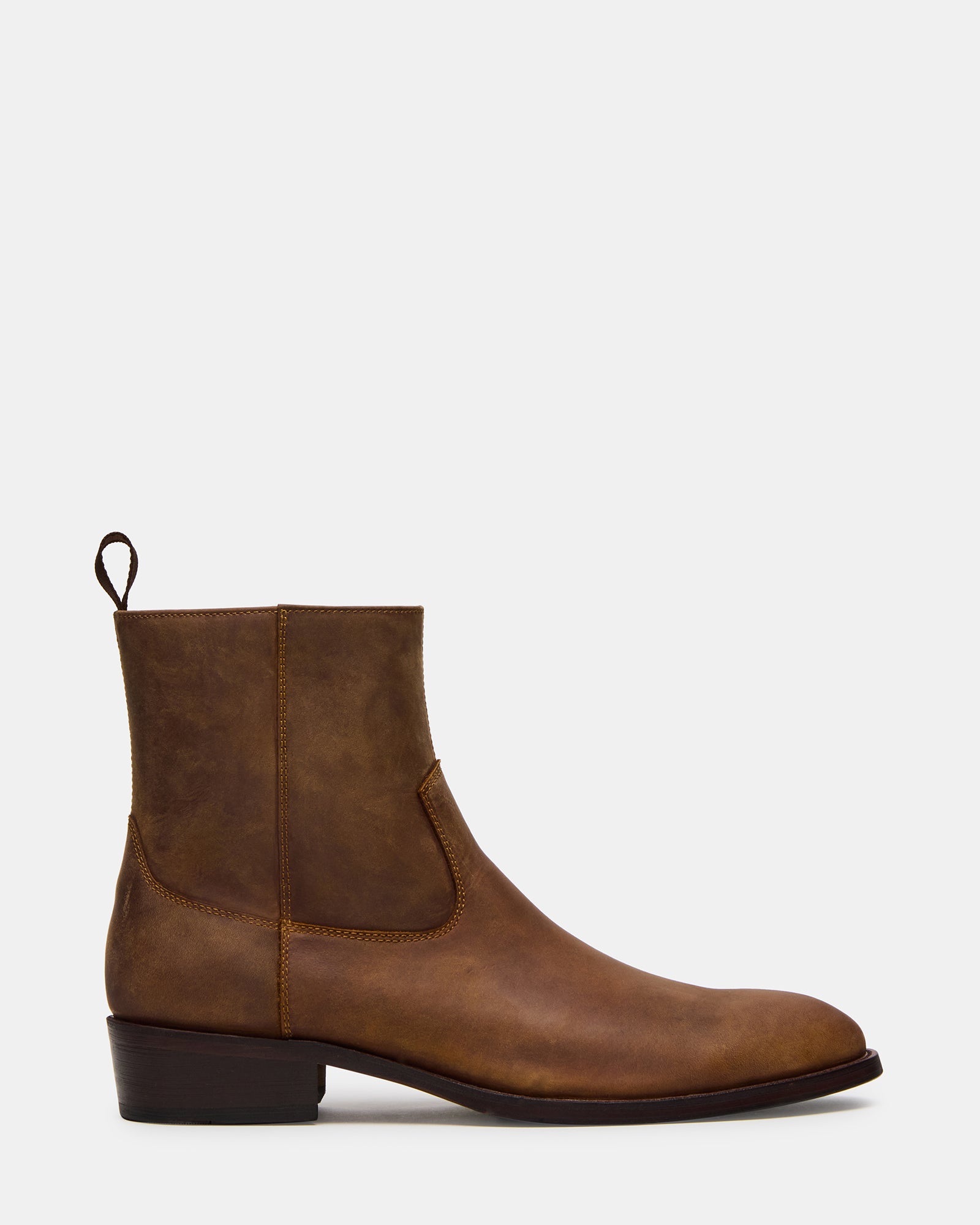 Front view of Hendrik tan leather boots on a wooden floor