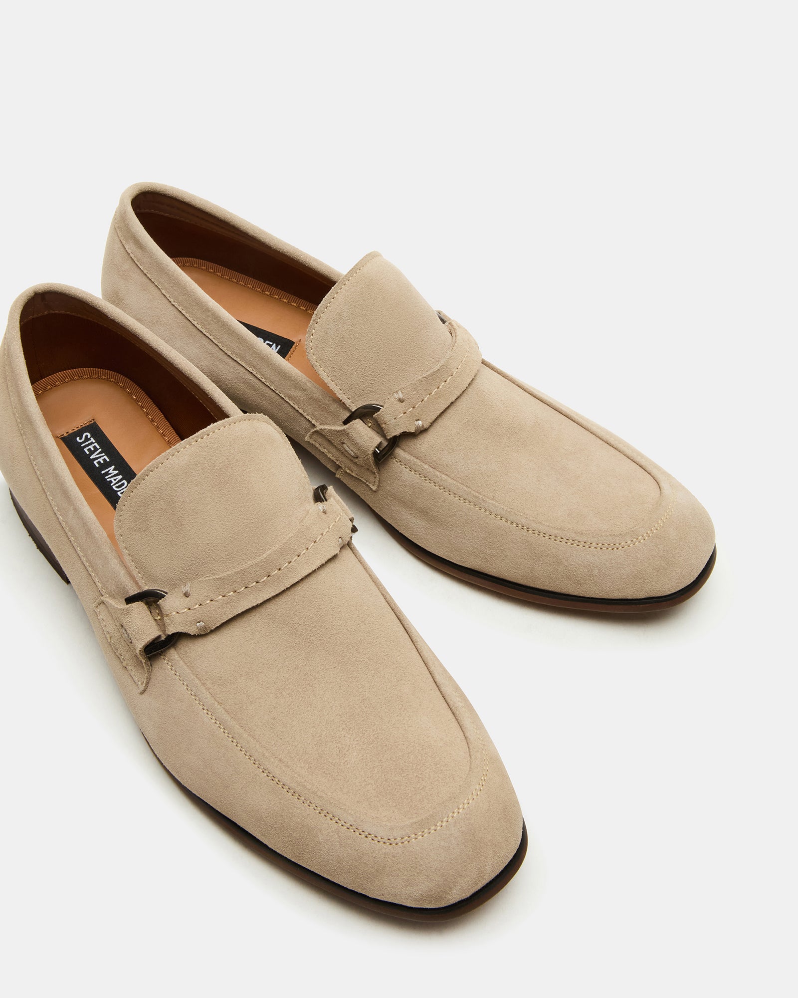 Side profile of slip-on suede loafers highlighting heel and sole
