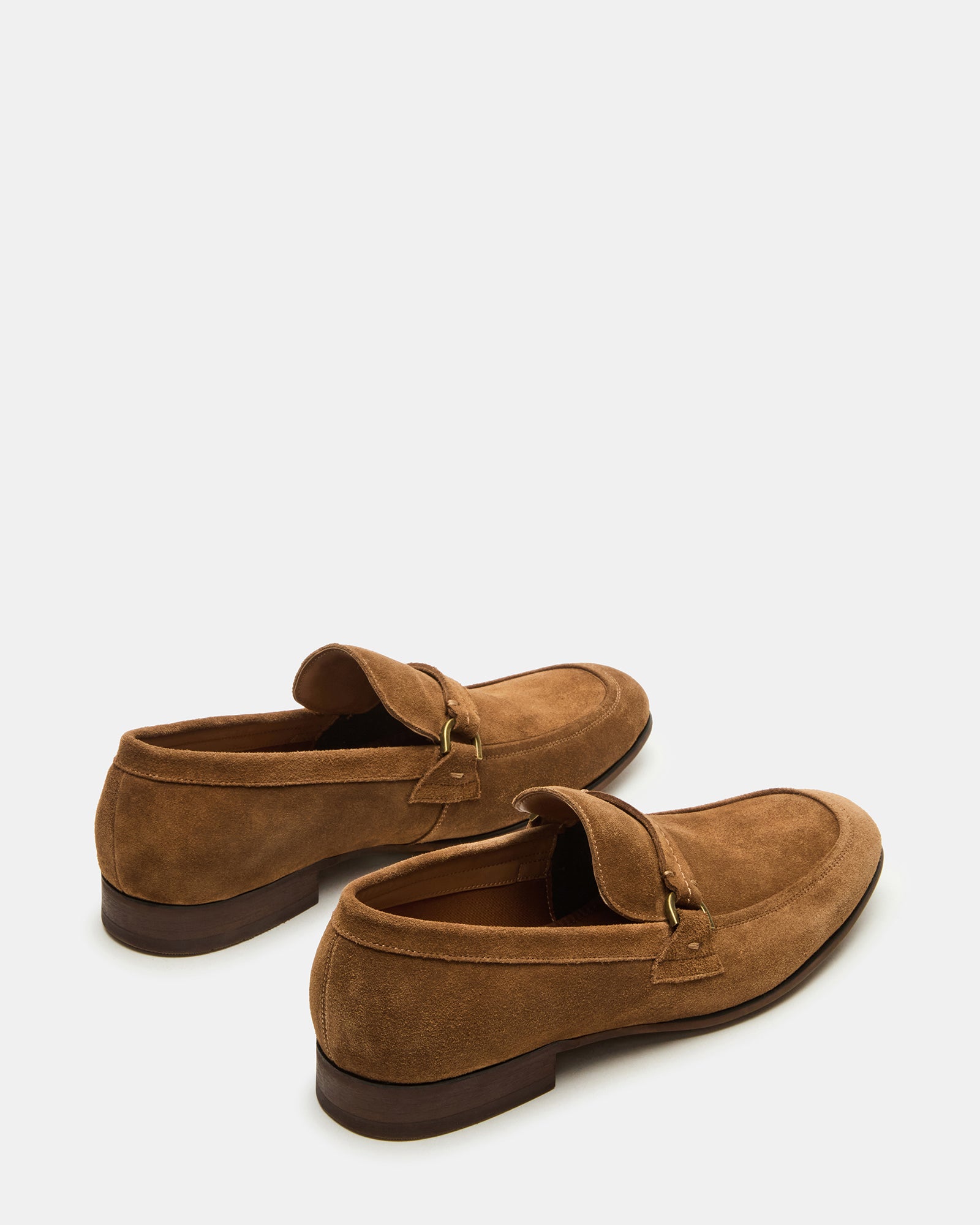Side view of HEROLF loafers placed on a hardwood floor, highlighting the elegant profile.