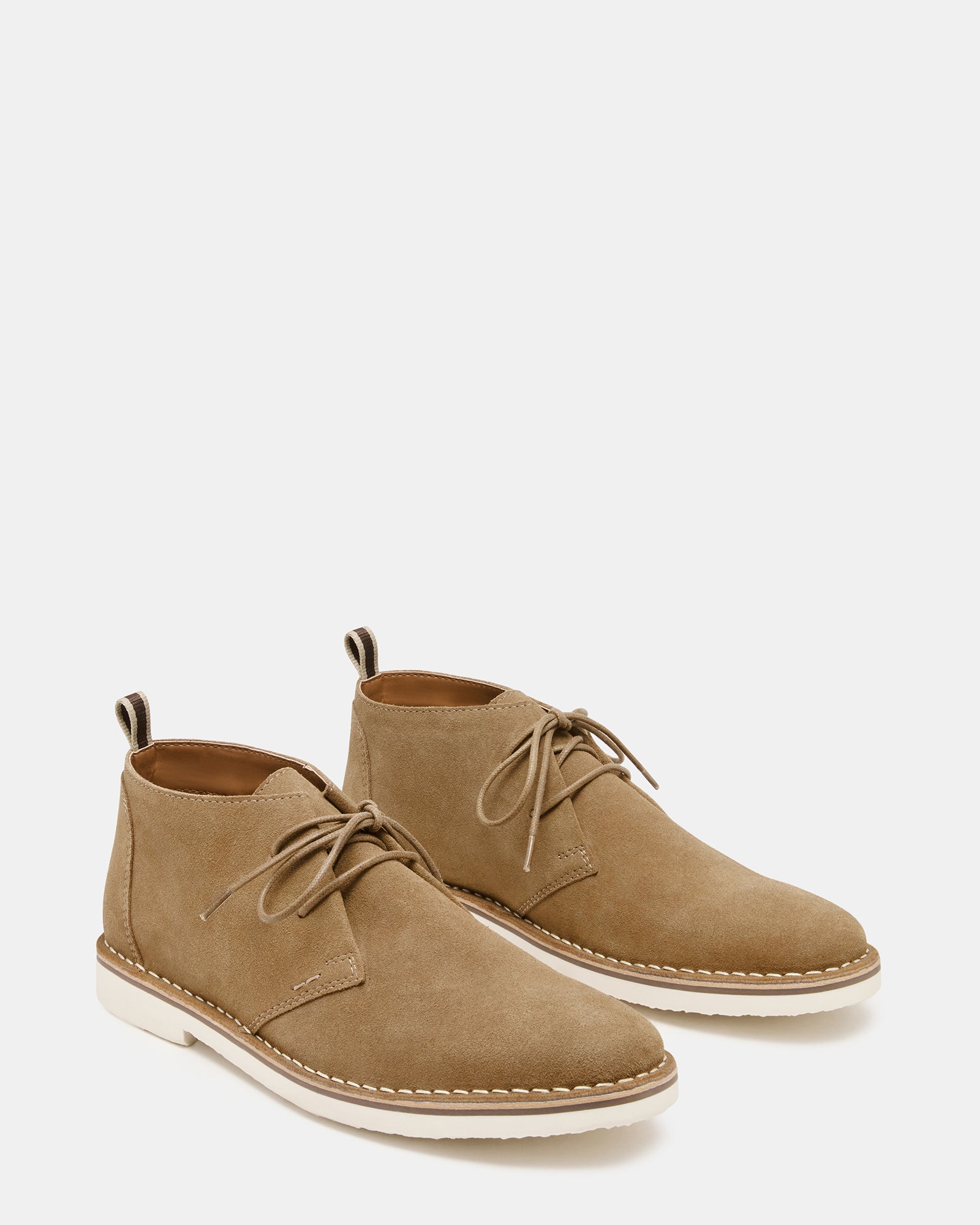 HERO cognac suede ankle boots styled with casual attire outdoors.