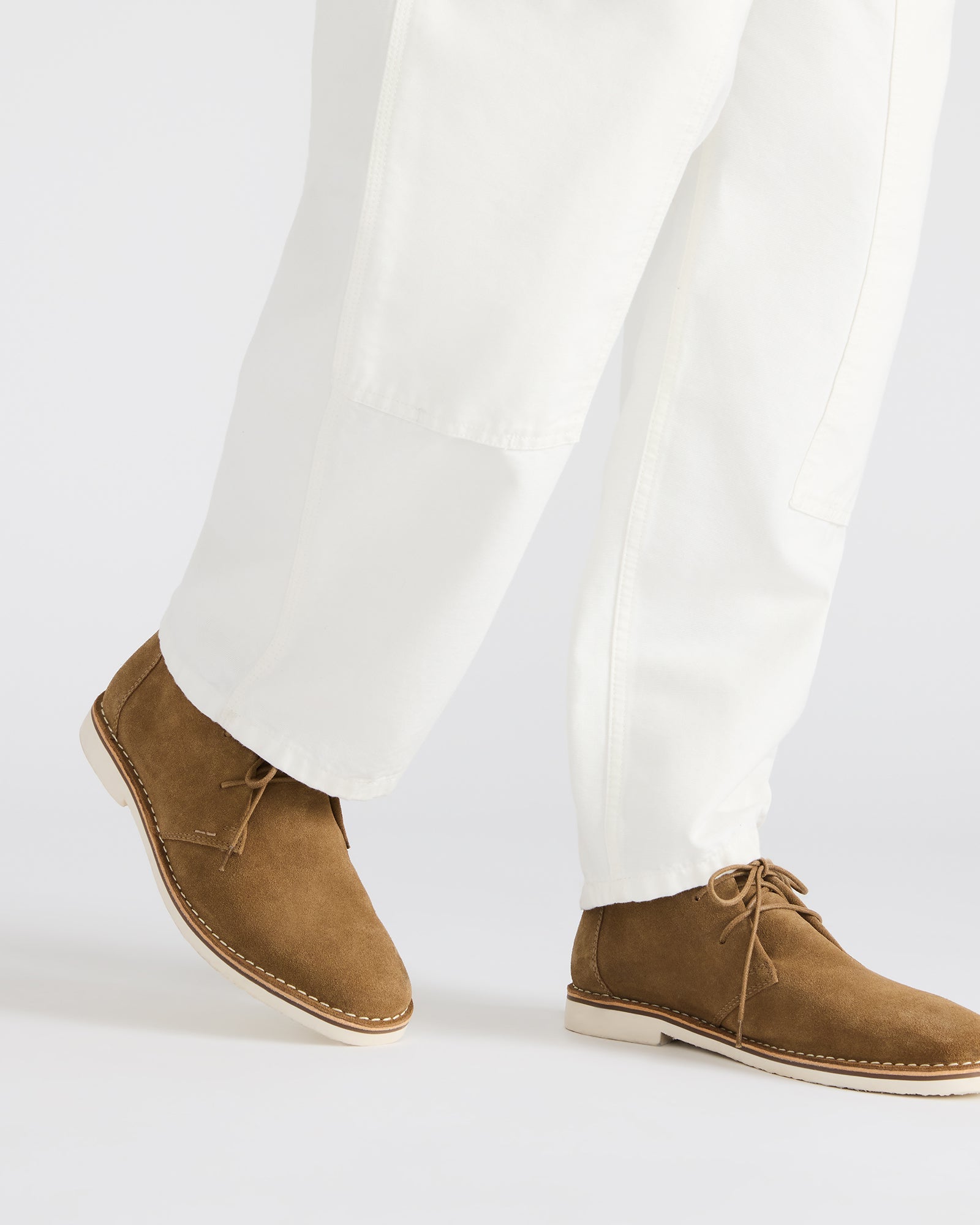 Close-up of the lace-up design of HERO cognac suede ankle boots.