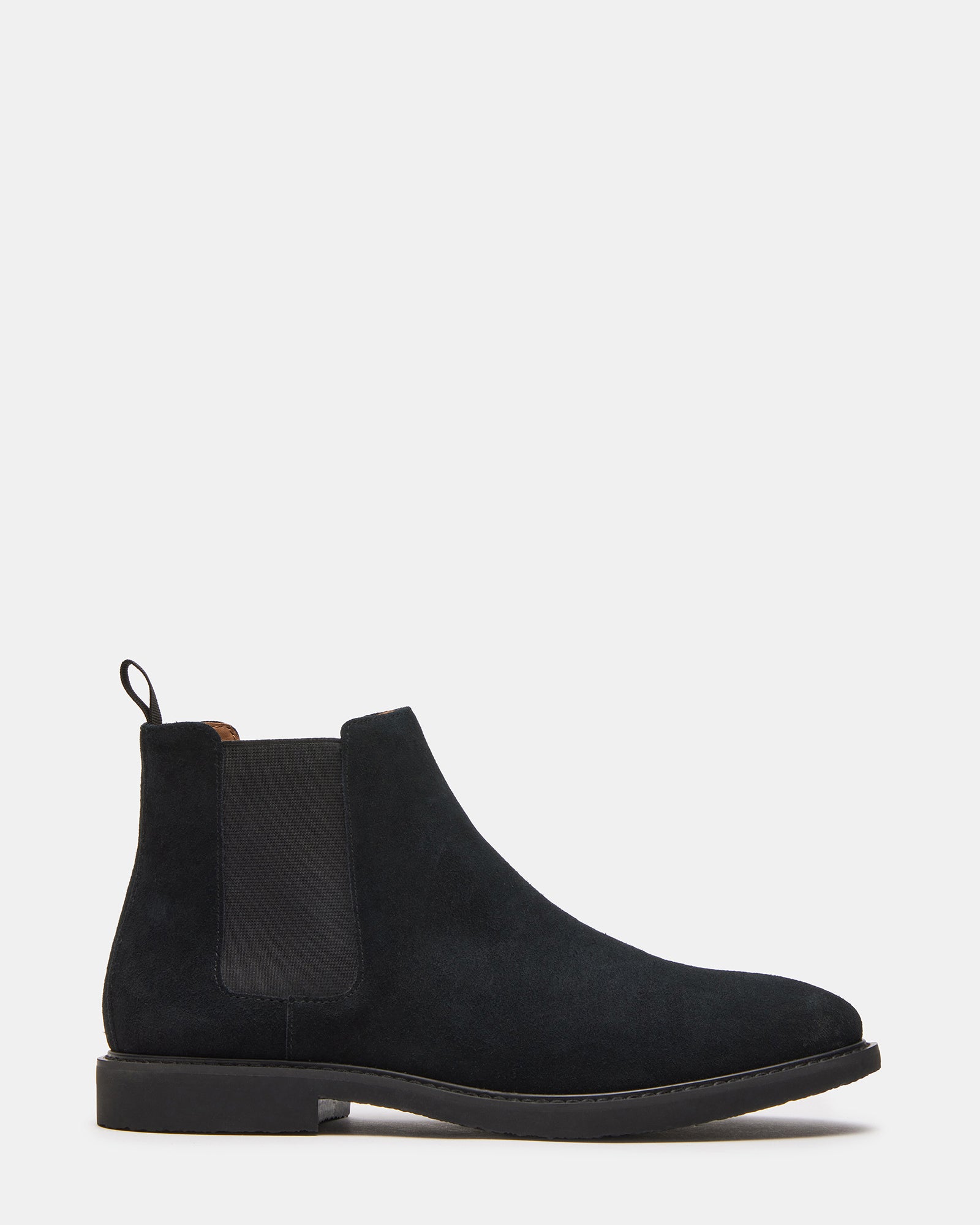 Side view of Highline black suede Chelsea boots on a model.