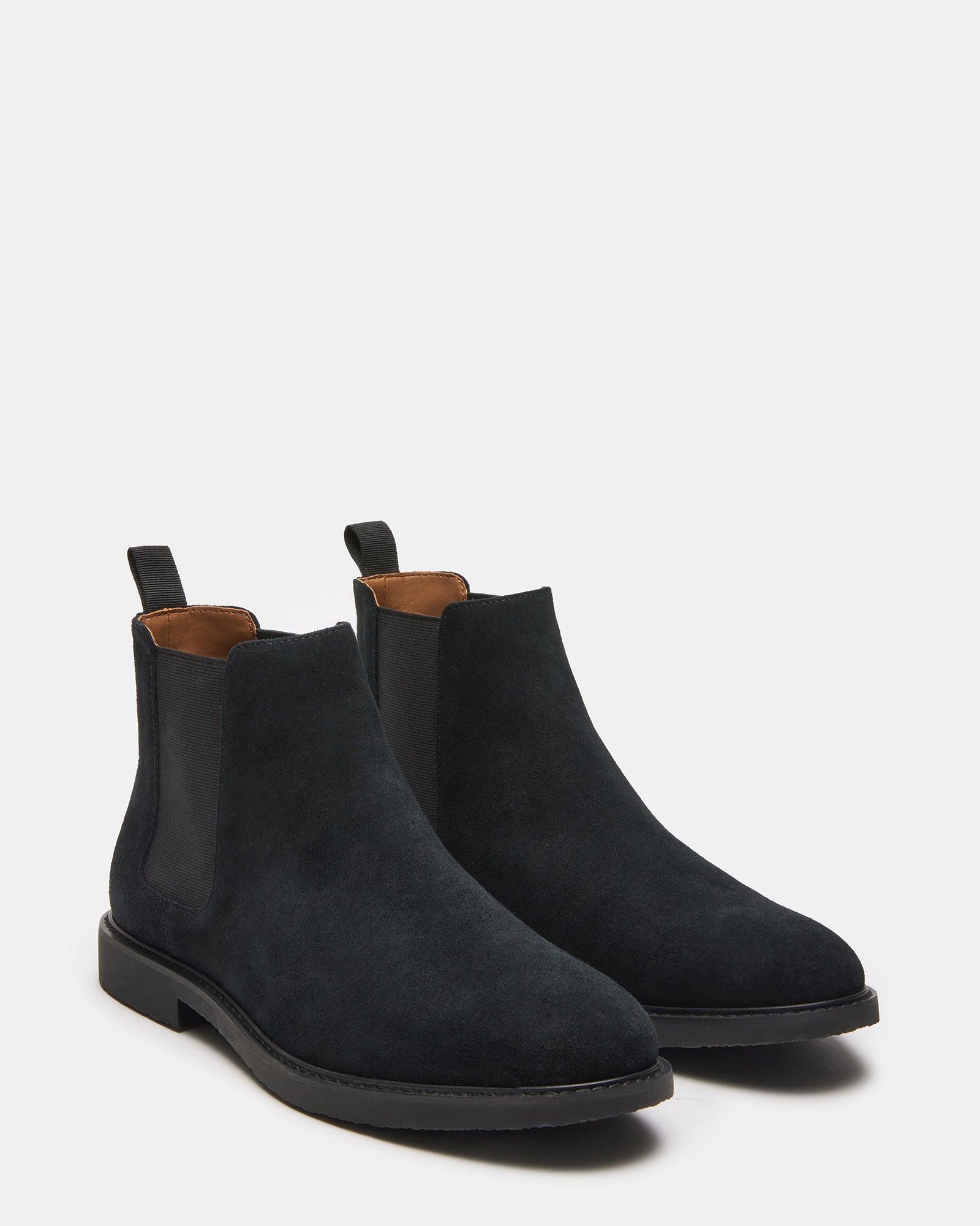 Close-up of the textured suede upper of the black ankle boots.