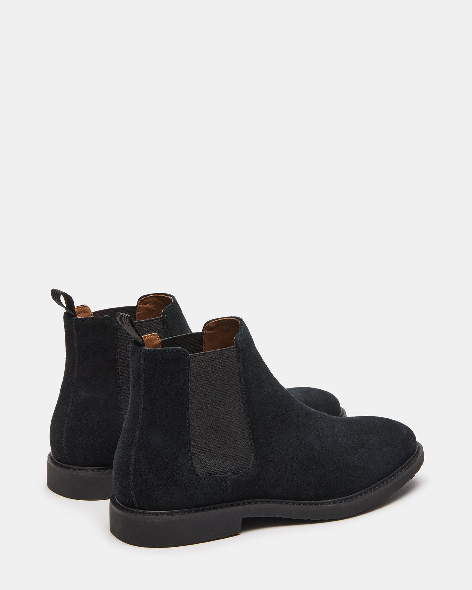 Close-up of the textured suede upper of the black ankle boots.