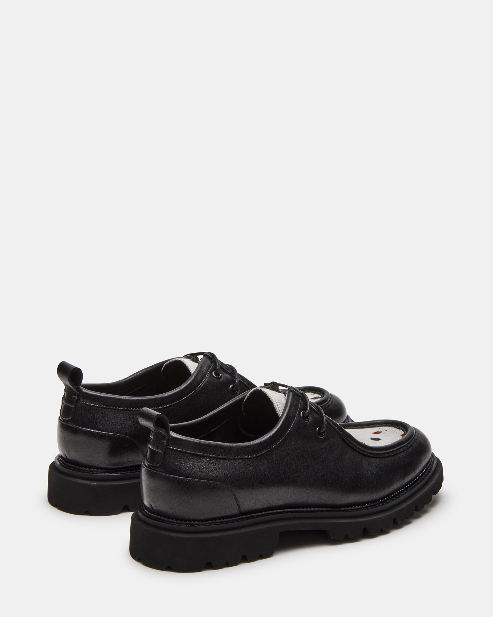 Side profile showing the 1.25-inch heel and textured rubber sole of these dress shoes