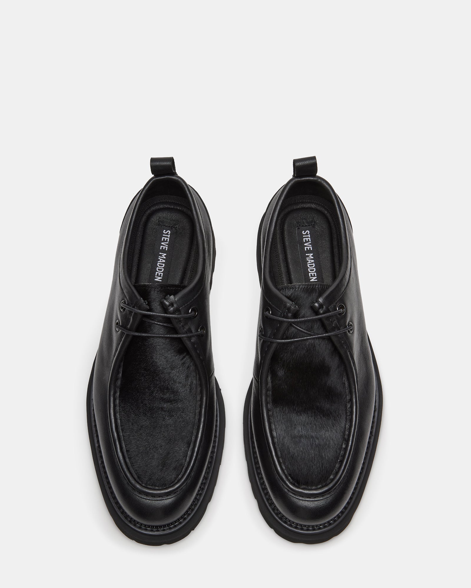 Side view of black formal shoes showing leather texture and heel height