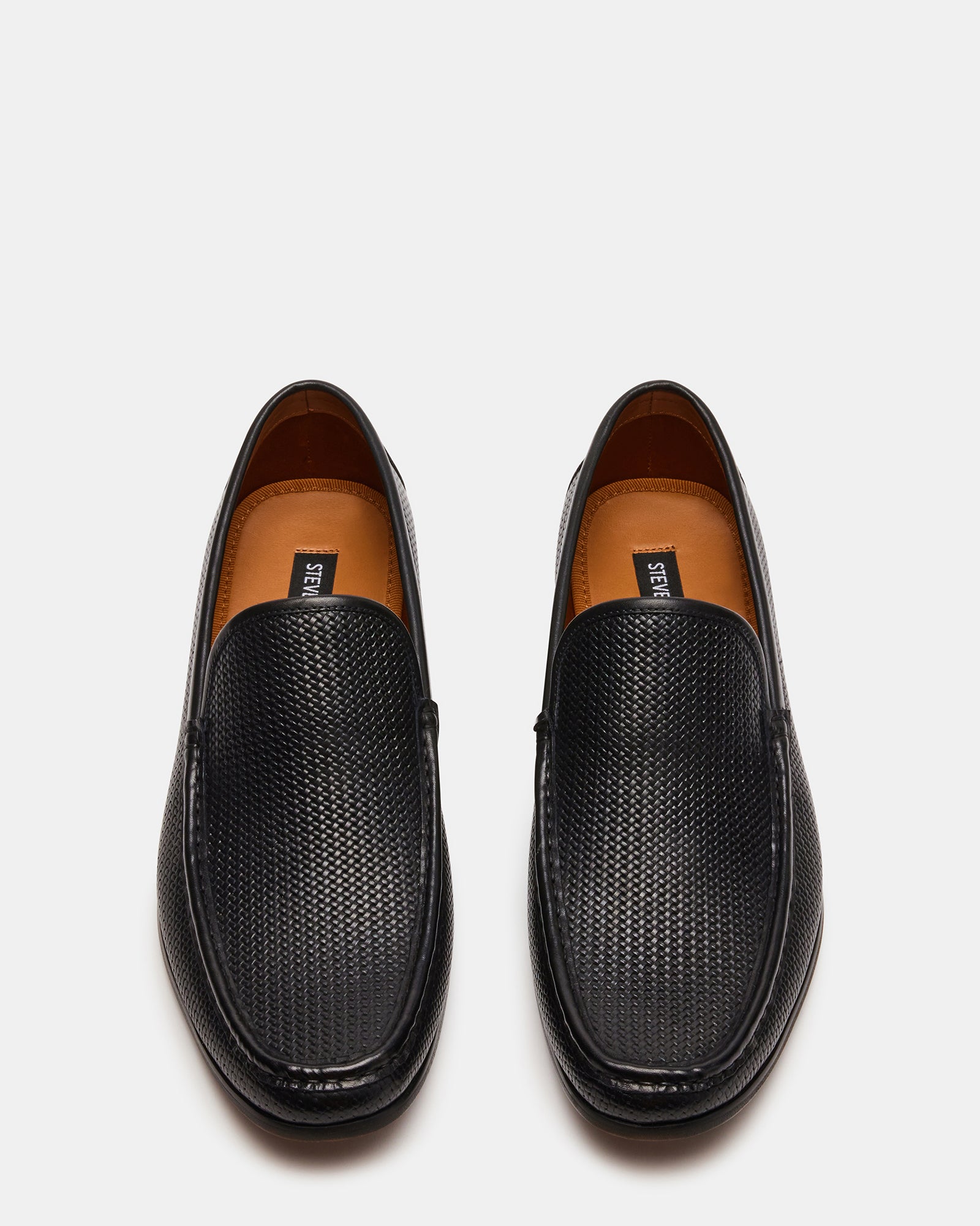 Black dress loafers shown at 45-degree angle on hardwood floor