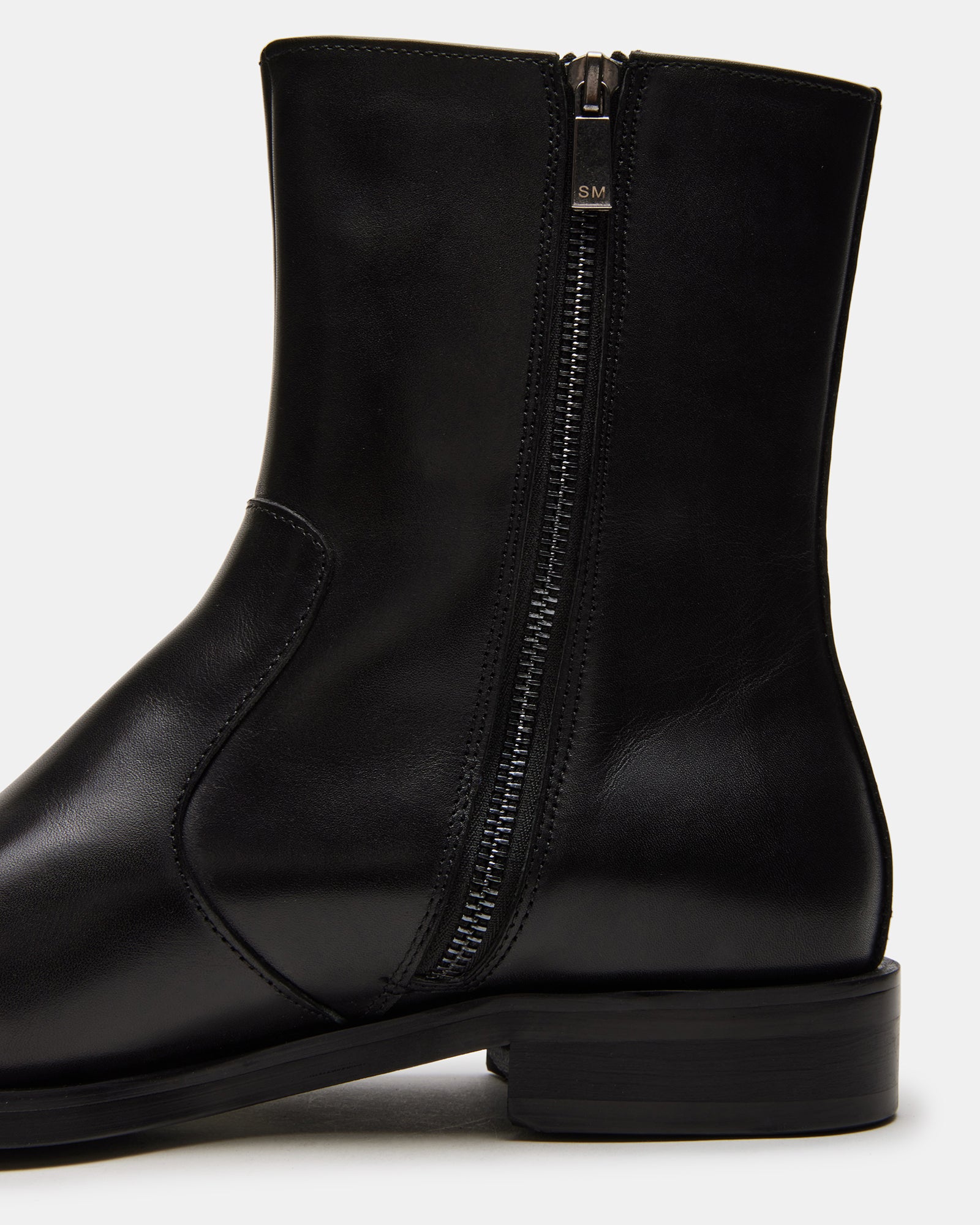 Model wearing black leather ankle boots, suitable for winter outfits