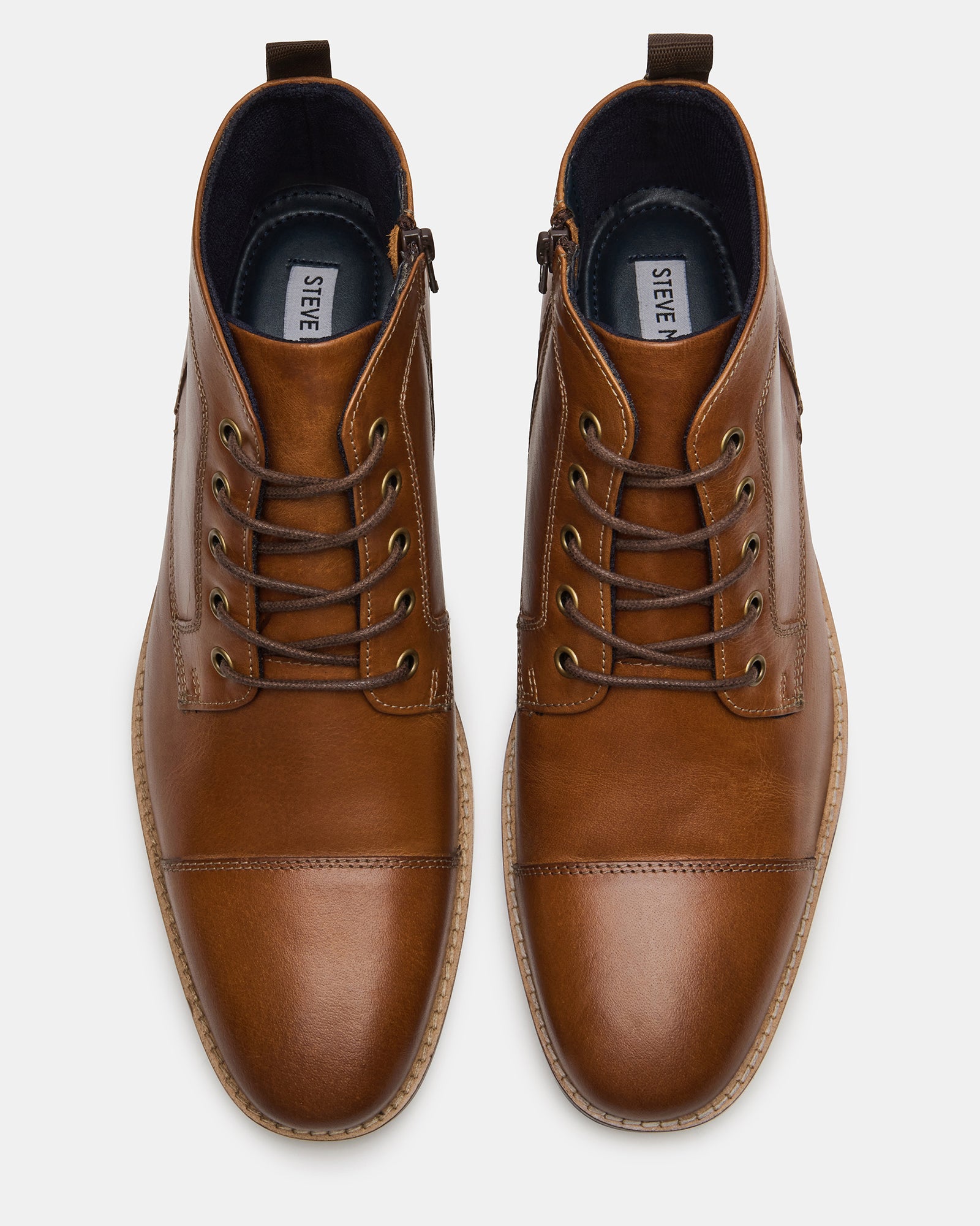 Top angle showing lace-up design and cap toe on black leather boots