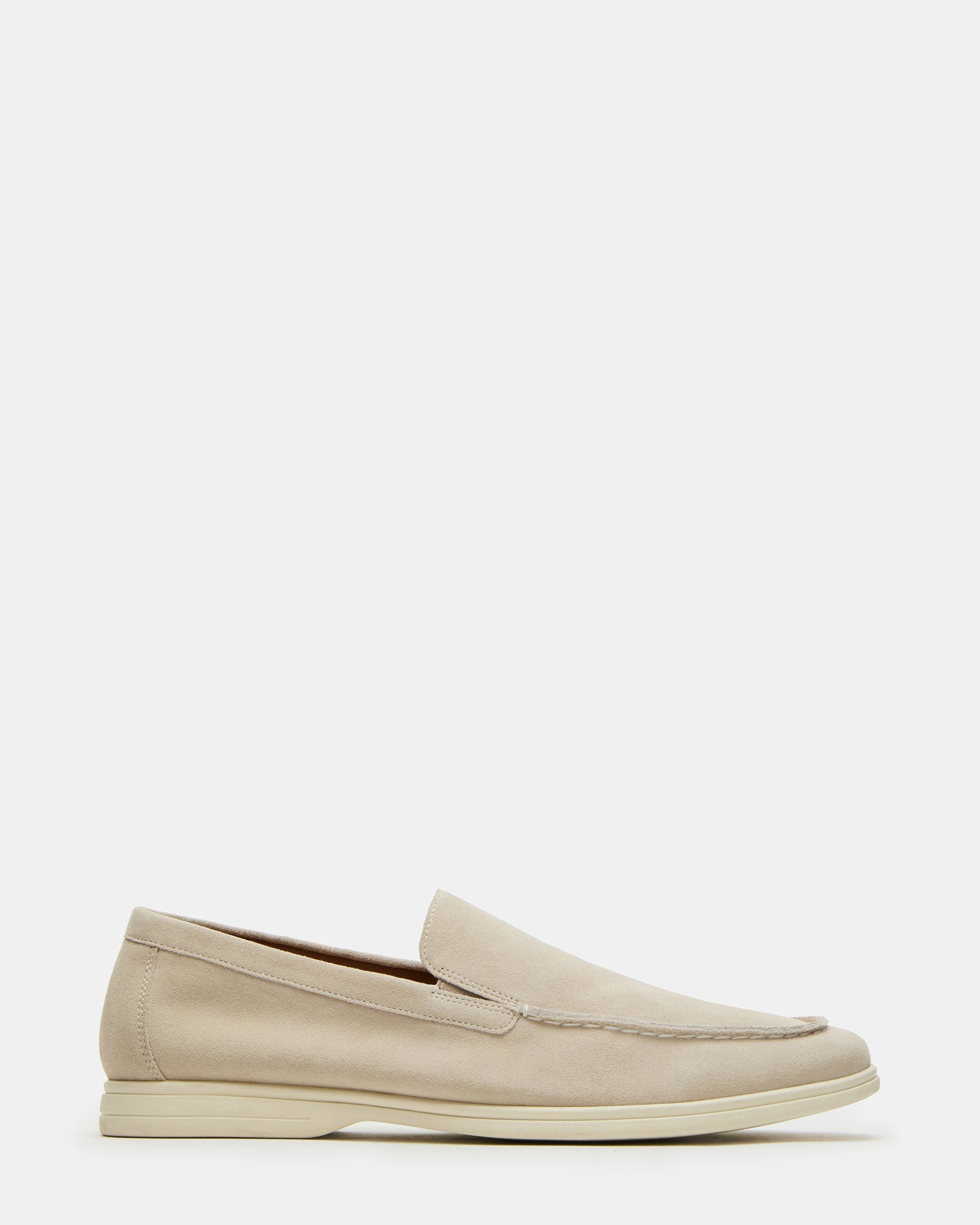 Side profile of beige slip-on shoes styled for business casual outfits